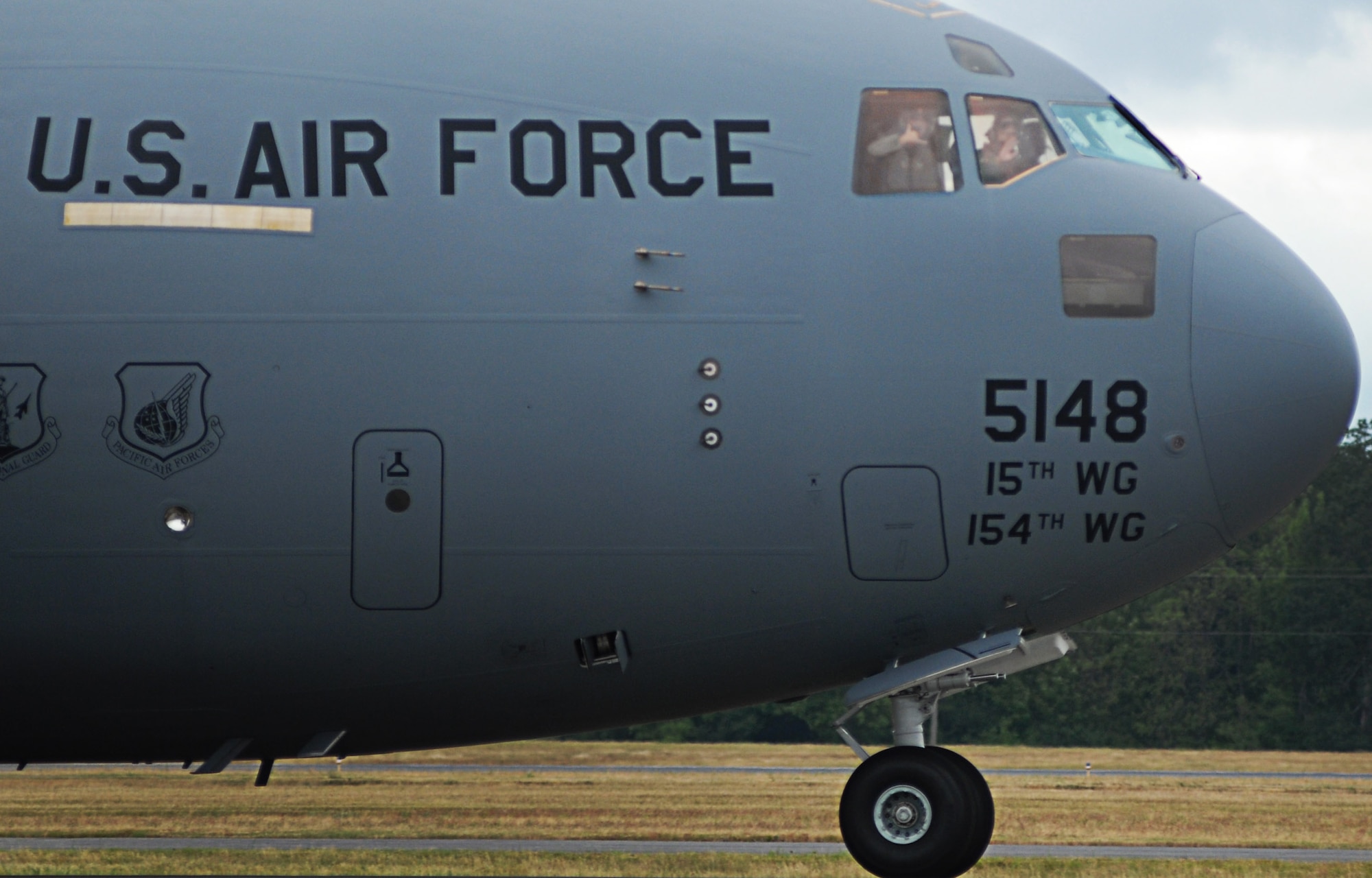 Pilots from the Pacific Air Forces C-17 Aerial Demonstration Team from Joint Base Pearl Harbor-Hickam, Hawaii, show "aloha" to the crowd at the Joint Base Lewis-McChord Air Expo 2012 at McChord Field, Washington July 22. The JBLM Air Expo 2012 featured 20 aerial performers and over 40 static aircraft displays. (U.S. Air Force photo by 2nd Lt. Jessica Colby) 
