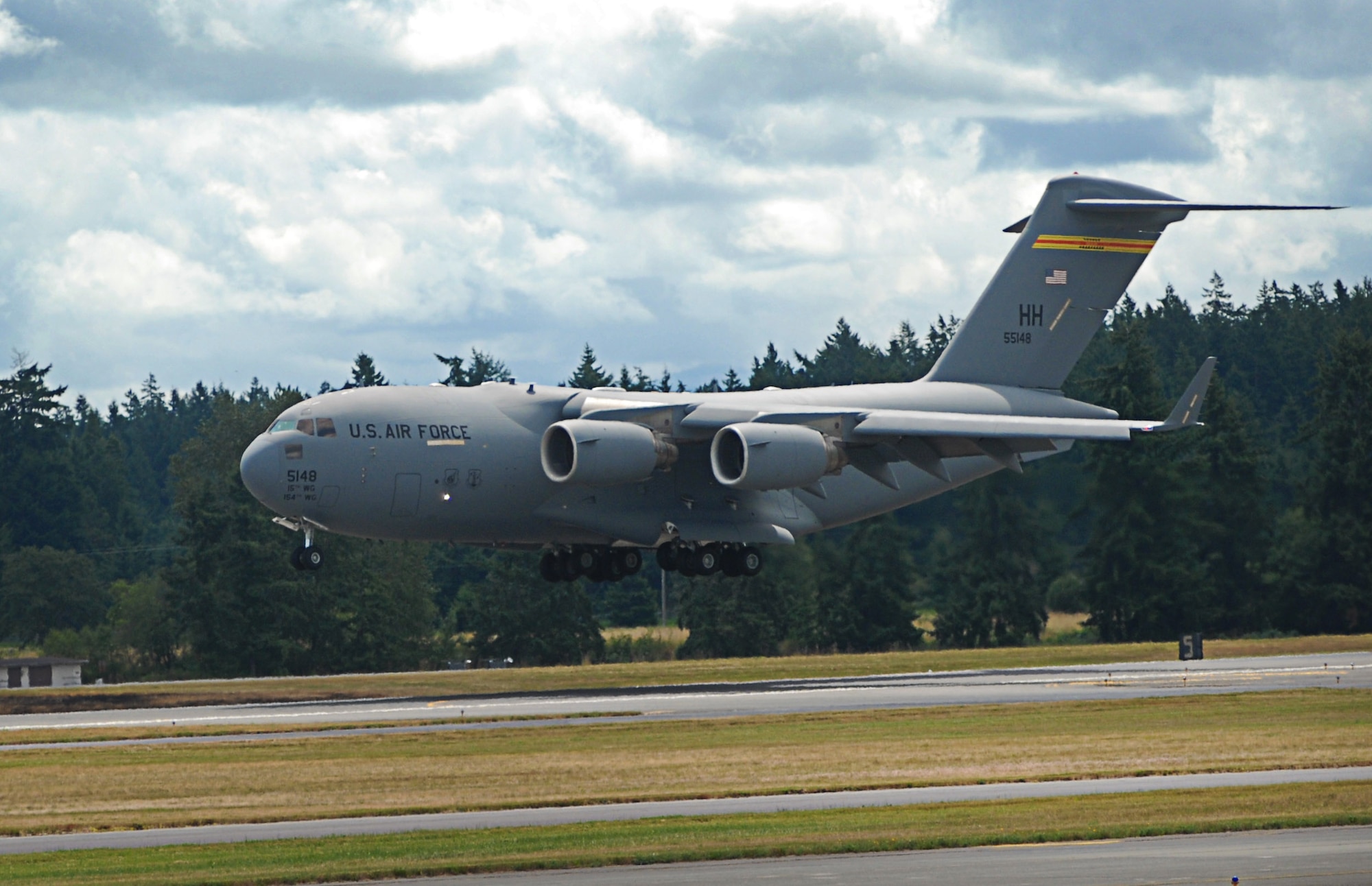 A C-17 Globemaster III from the 535th Airlift Squadron at Joint Base Pearl Harbor-Hickam, Hawaii, prepares to land as part of the Pacific Air Forces C-17 Aerial Demonstration Team at the Joint Base Lewis-McChord Air Expo 2012 at McChord Field, Washington July 21. The JBLM Air Expo 2012 featured 20 aerial performers and over 40 static aircraft displays. (U.S. Air Force photo by 2nd Lt. Jessica Colby)