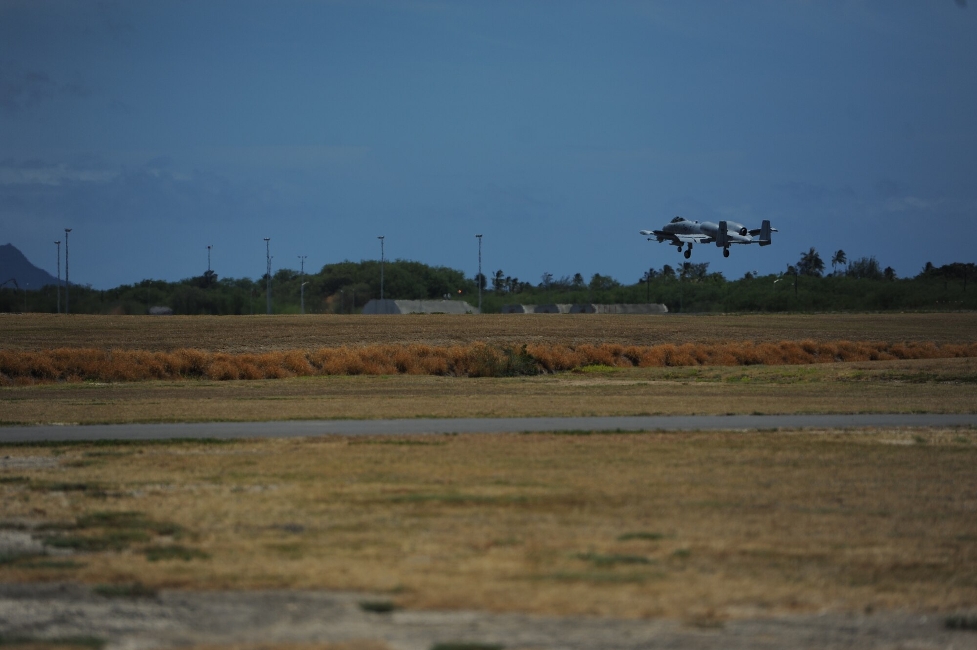 An A-10 Thunderbolt II lands at Joint Base Pearl Harbor-Hickam, Hawaii July 23 during a sortie for the Rim of the Pacific exercise. Joint and coalition forces gathered at JBPHH for RIMPAC, the world's largest international maritime warfare exercise.  (U.S. Air Force photo by Staff Sgt. Nathan Allen)