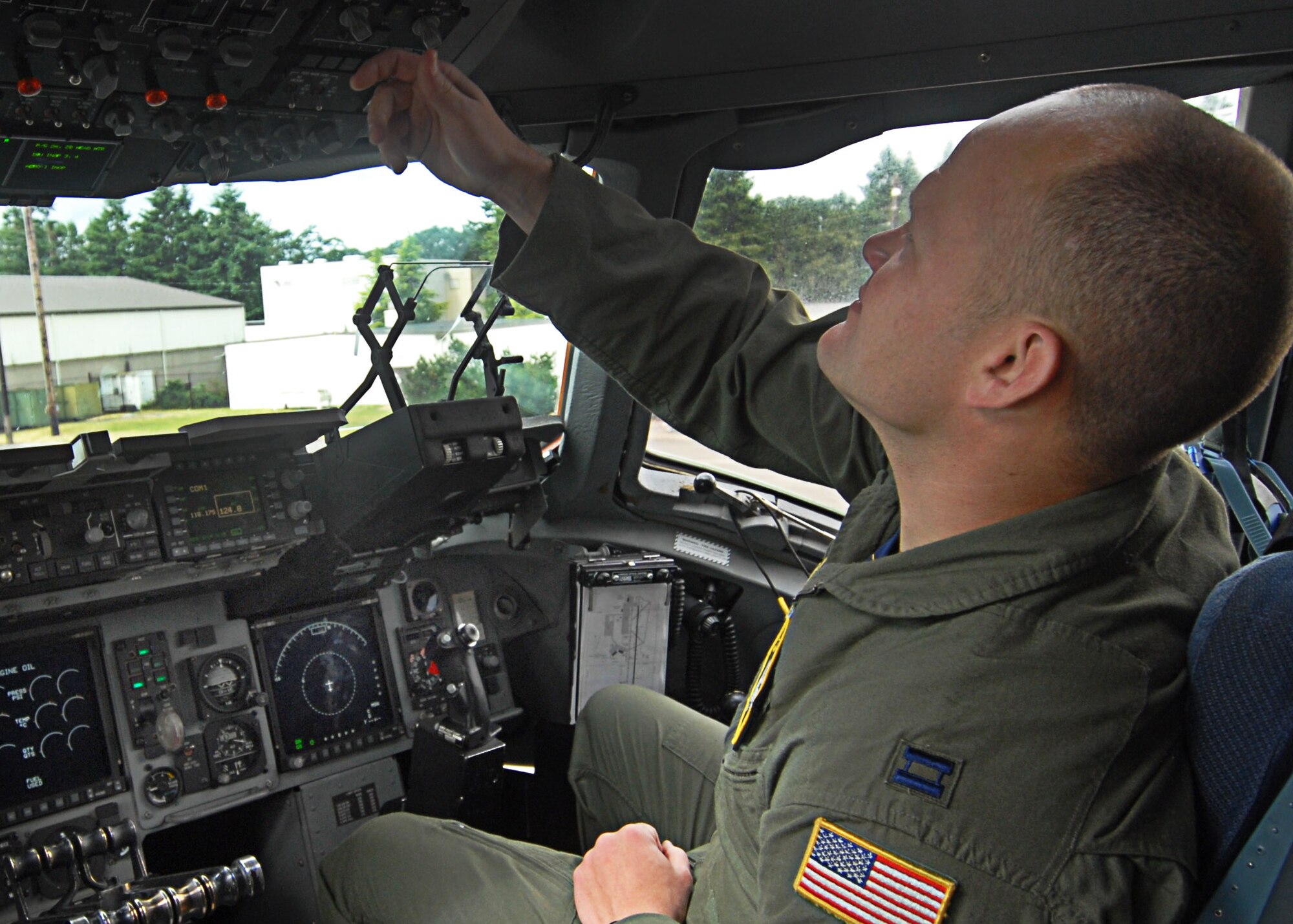 Capt. Chris Ross, a pilot on the Pacific Air Forces C-17 Aerial Demonstration Team from Joint Base Pearl Harbor-Hickam, Hawaii, makes final pre-flight preparations prior to performing at the Joint Base Lewis-McChord Air Expo 2012 at McChord Field, Washington July 21. The JBLM Air Expo 2012 featured 20 aerial performers and over 40 static aircraft displays. (U.S. Air Force photo by 2nd Lt. Jessica Colby) 