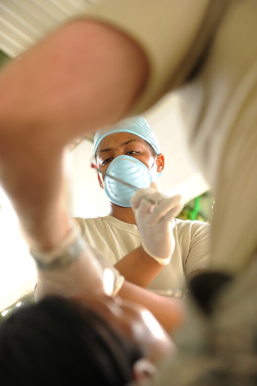 Air Force Tech. Sgt. Meshiek Harris, dental technician, JTF-Bravo holds a tooth after extraction by Air Force Maj. Brent Waldmen during the third day of a Medical Readiness Training Exercise on the island of Nargana, July 18.(Official photo by Tech. Sgt. Brannen Parrish)