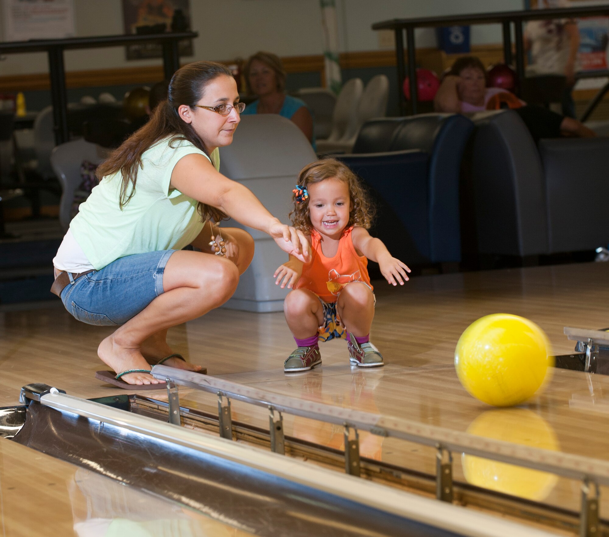 Sarah McVay and her daughter Lena, wife and daughter to Capt. Dan McVay 15th AMOS C-17 Globemaster III pilot, bowl at Travis Bowl Tuesday. With a PLAYpass card, members can get discounted rates on bowling and rentals at the Travis Bowl. (U.S. Air Force photo/Airman 1st Class Nicole Leidholm)