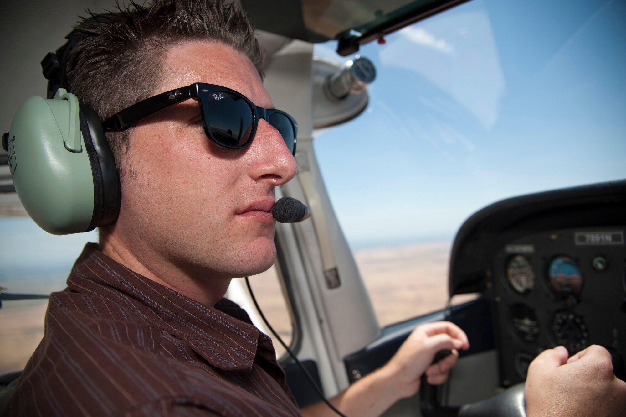 Chris Latham, 60th Force Support Squadron Aero Club manager, fly a Cessna over Travis July 16. Travis personnel can get a membership for the facility and learn how to fly. PLAYpass members can use their card for flying lessons at the Aero Club. (U.S. Air Force photo/Airman 1st Class Nicole Leidholm)