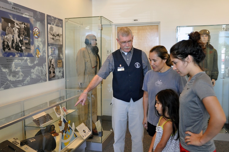 Mike Miller, a volunteer docent at the Peterson Air and Space Museum, talks to visitors about one of the museum’s many displays. (U.S. Air Force photo/Dan Santistevan)