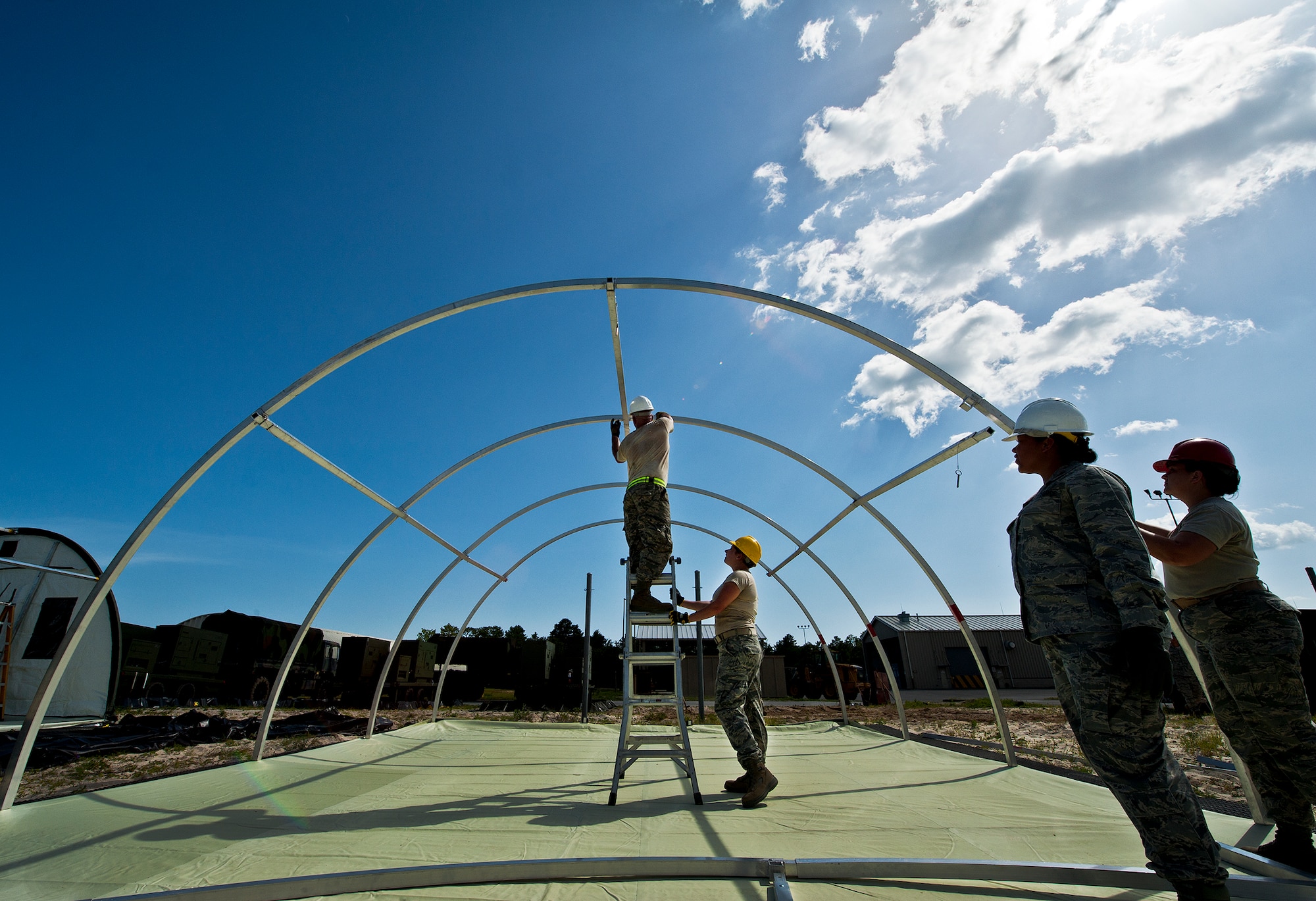 728 ACS personnel construct an Alaskan shelter on their ‘deployed site’ during a deployment readiness exercise called Bison Fury July 24 at Eglin Air Force Base, Fla.  This exercise marks the last large-scale exercise for the squadron, which is scheduled to be deactivated in 2013.  (U.S. Air Force photo/Samuel King Jr.)