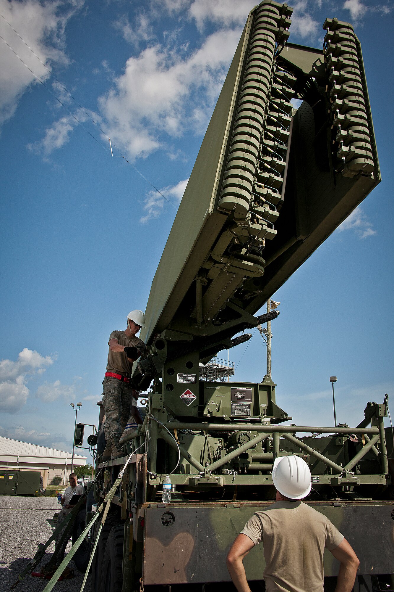 Airman 1st Class Daniel Hilliard hand cranks the deployment of a TPS-75 radar set antenna in support a 728th Air Control Squadron deployment readiness exercise called Bison Fury July 24 at Eglin Air Force Base, Fla.  This exercise marks the last large-scale exercise for the squadron, which is scheduled to be deactivated in 2013.  (U.S. Air Force photo/Samuel King Jr.)