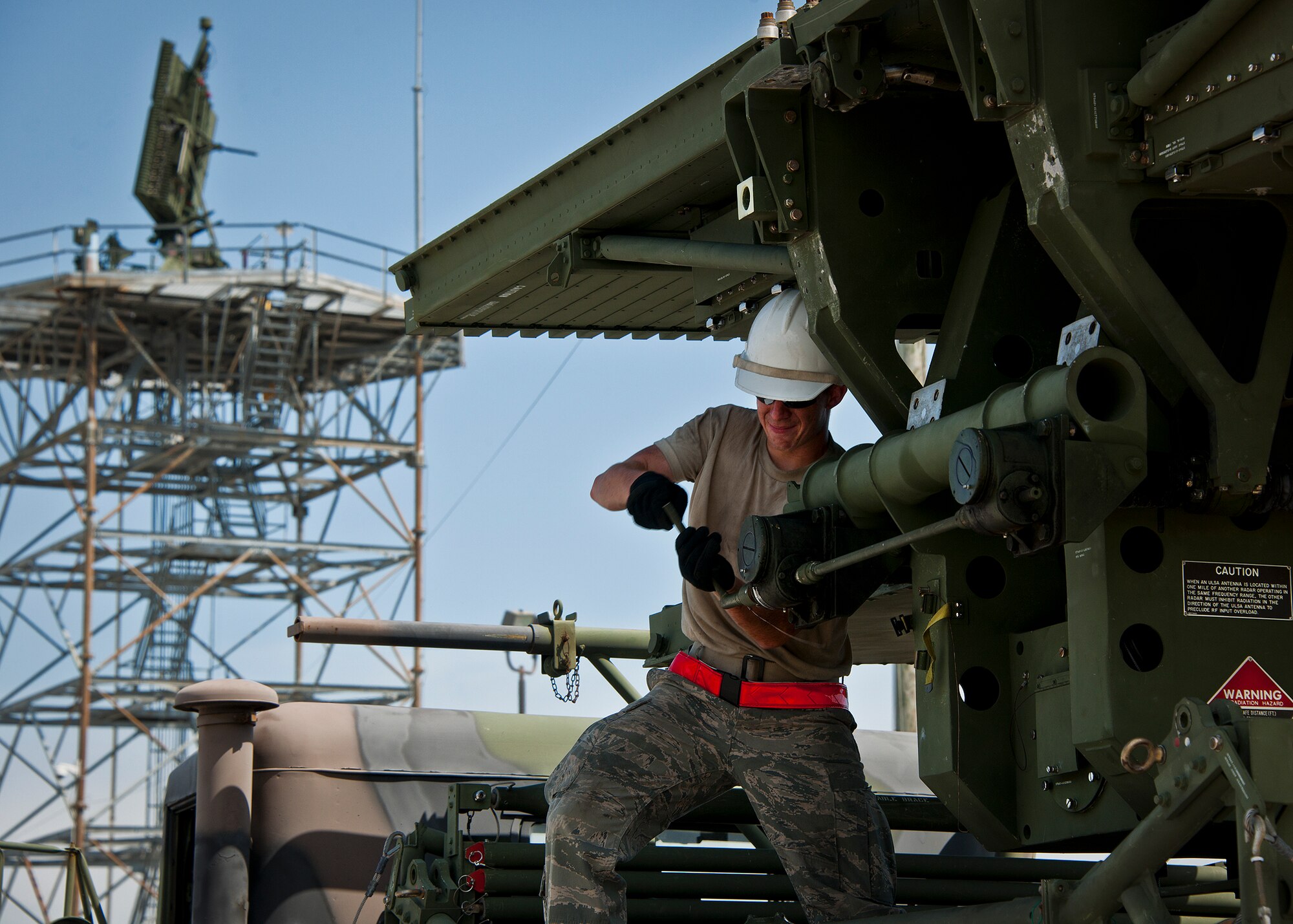 Airman 1st Class Daniel Hilliard hand cranks the deployment of a TPS-75 radar set antenna in support a 728th Air Control Squadron deployment readiness exercise called Bison Fury July 24 at Eglin Air Force Base, Fla.  This exercise marks the last large-scale exercise for the squadron, which is scheduled to be deactivated in 2013.  (U.S. Air Force photo/Samuel King Jr.)