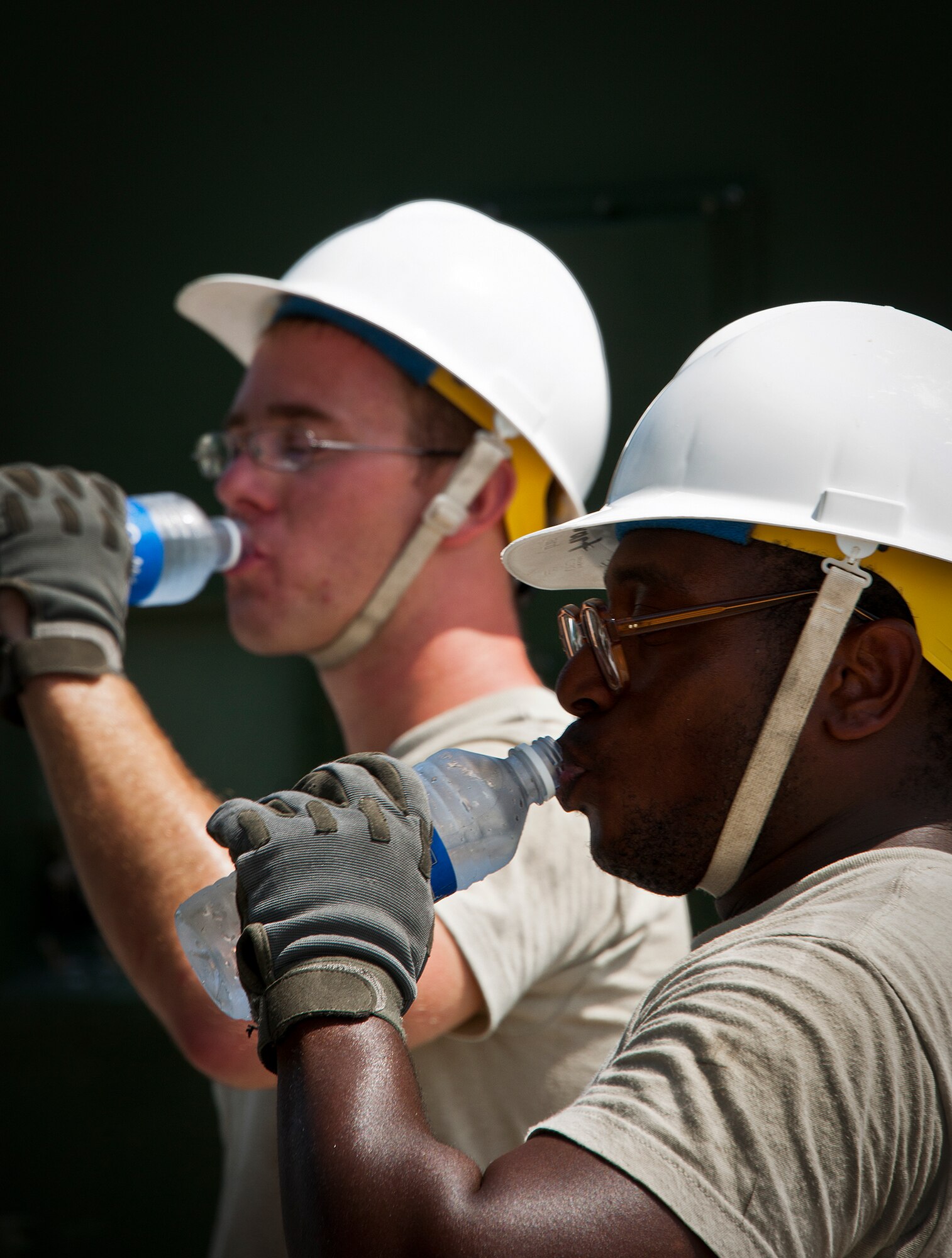 Senior Airman Darnell Stewart and Airman 1st Class Matthew Buxkemper, take a hydration break during a 728th Air Control Squadron deployment readiness exercise called Bison Fury July 24 at Eglin Air Force Base, Fla.  Temperatures climbed over 95 degrees and rest and hydration breaks were mandated.  This exercise marks the last large-scale exercise for the squadron, which is scheduled to be deactivated in 2013.  (U.S. Air Force photo/Samuel King Jr.)