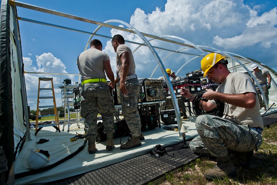 Airmen from the 728th Air Control Squadron begin initial setup of a deployed radar site during a deployment readiness Exercise called Bison Fury July 24 at Eglin Air Force Base, Fla.  This exercise marks the last large-scale exercise for the squadron, which is scheduled to be deactivated in 2013.  (U.S. Air Force photo/Samuel King Jr.)