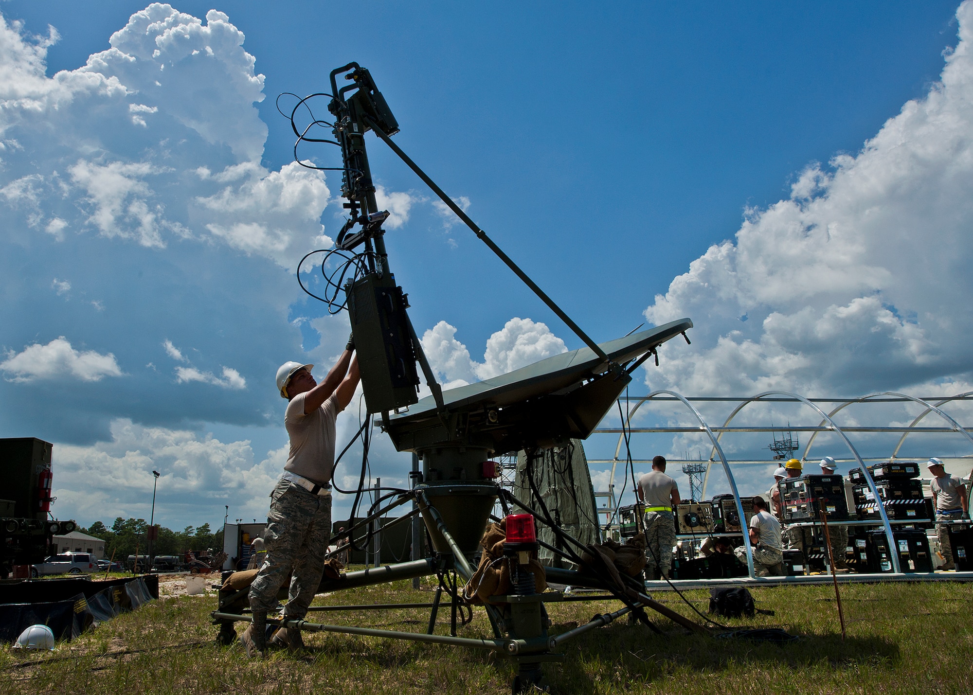 Airman 1st Class Jorge Duarte attaches a flux gate compass to a ground multi-band terminal satellite antenna during a 728th Air Control Squadron deployment readiness exercise called Bison Fury July 24 at Eglin Air Force Base, Fla.  This exercise marks the last large-scale exercise for the squadron, which is scheduled to be deactivated in 2013.  (U.S. Air Force photo/Samuel King Jr.)