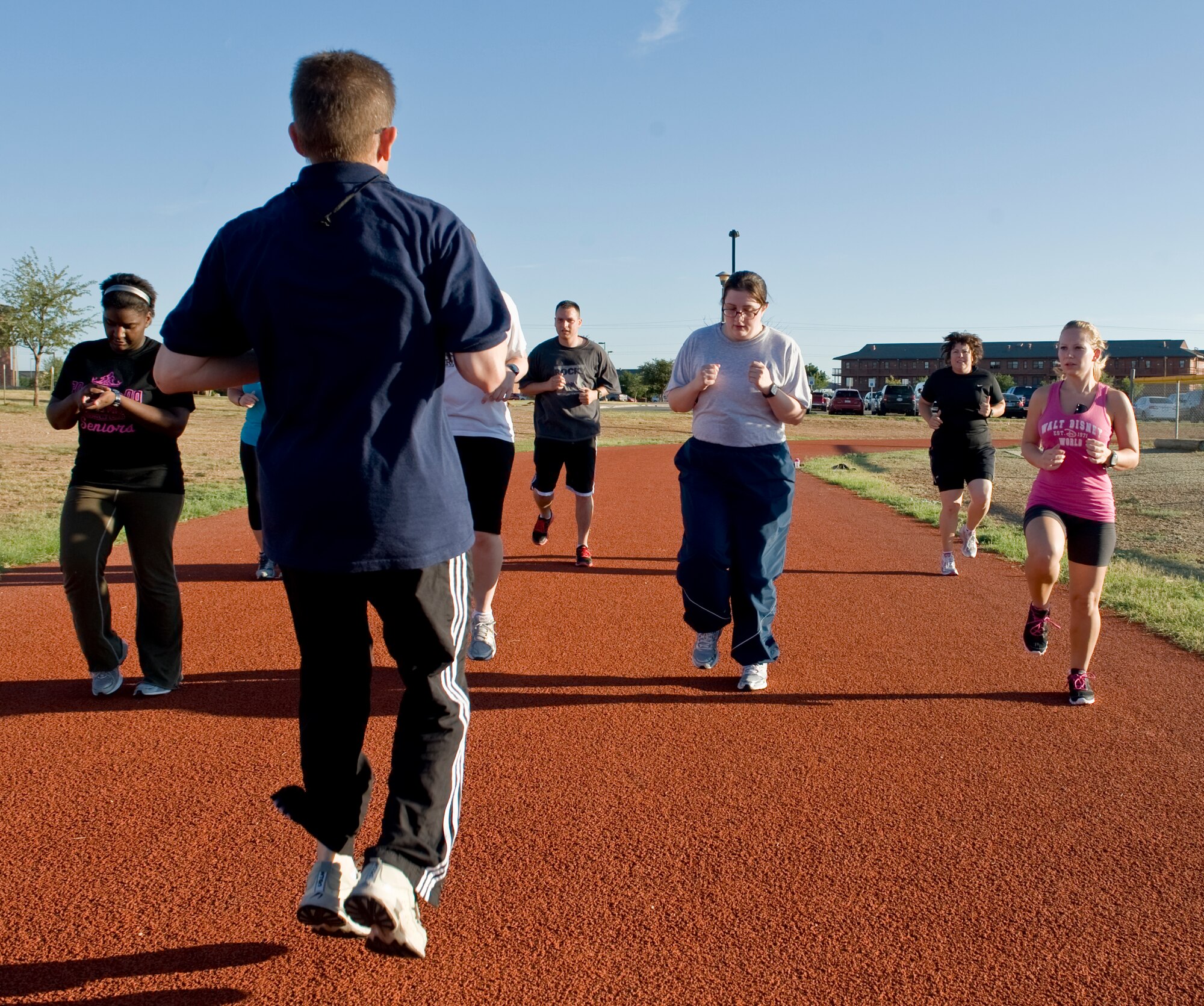 Members of a running program work on proper body motion July 19, 2012, at Dyess Air Force Base, Texas. The run program, designed by the Health and Wellness Center, improves Airmen’s cardiovascular strength and endurance, informs them on running essentials and trains them to be able to run for much longer distances at a faster pace than when they started. (U.S. Air Force photo by Airman 1st Class Peter Thompson/ Released)