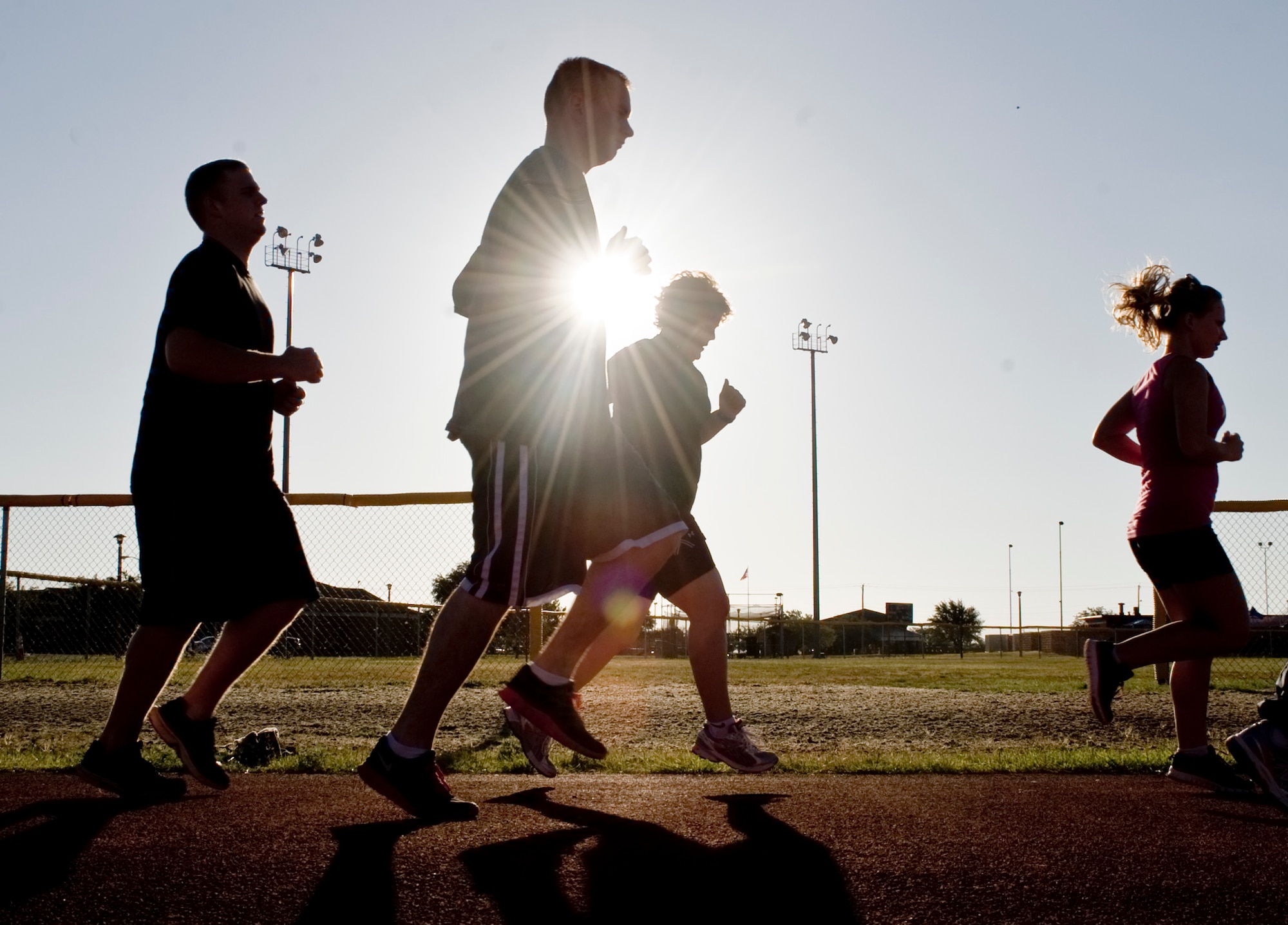 Members of a running program work on proper body motion July 19, 2012, at Dyess Air Force Base, Texas. The run program, designed by the Health and Wellness Center, improves Airmen’s cardiovascular strength and endurance, informs them on running essentials and trains them to be able to run for much longer distances at a faster pace than when they started. (U.S. Air Force photo by Airman 1st Class Peter Thompson/ Released)