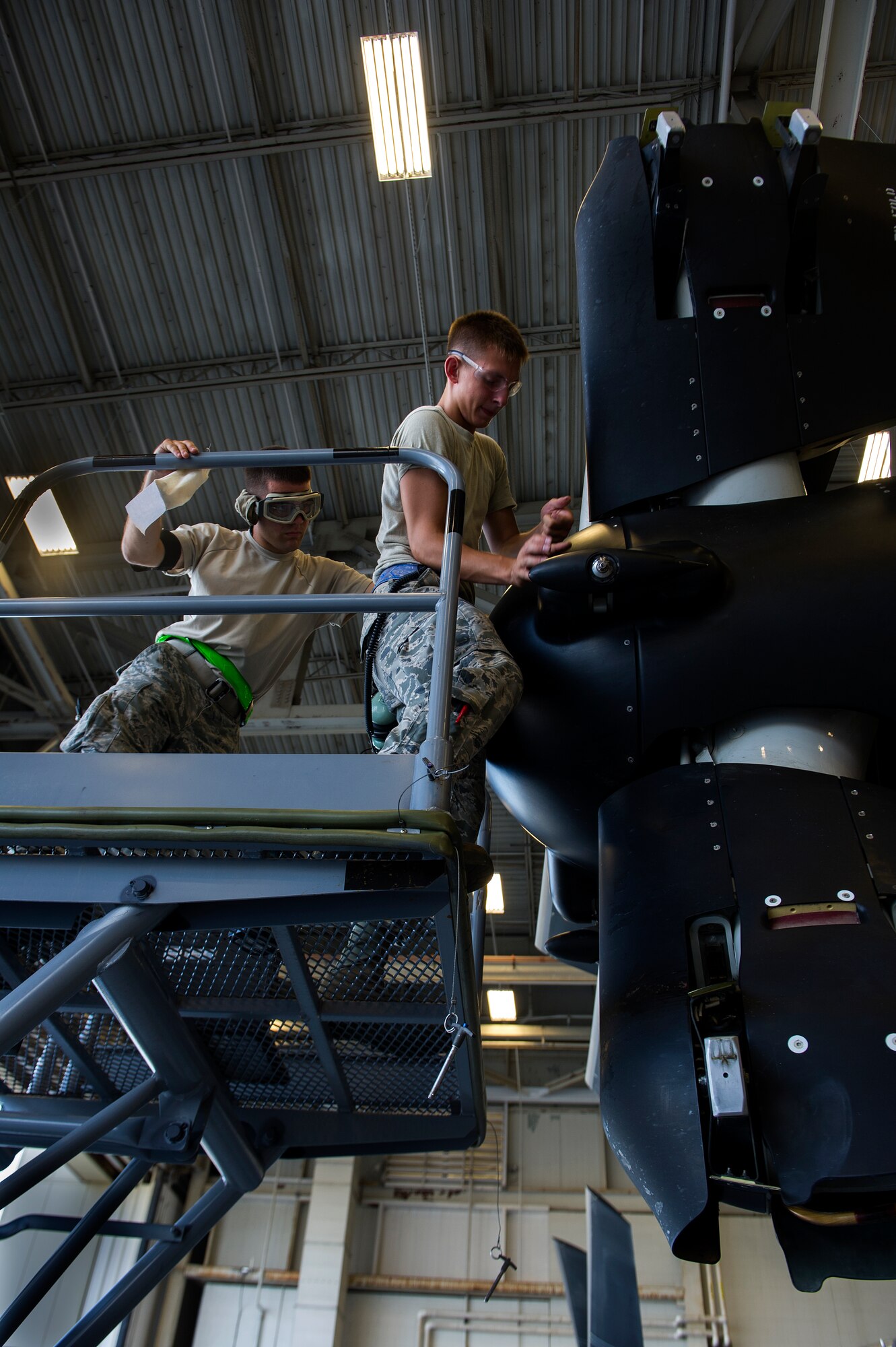 U.S. Air Force Airmen from 801st Special Operations Aircraft Maintenance Squadron take off the propeller cap before starting maintenance on a CV-22 at the Freedom Hangar on Hurlburt Field, Fla., July 17, 2012. The 801st SOAMXS changed their name June 1st, 2009 from the 1st Special Operations Helicopter Maintenance Squadron. (U.S. Air Force photo/Airmen 1st Class Christopher Williams)(Released)