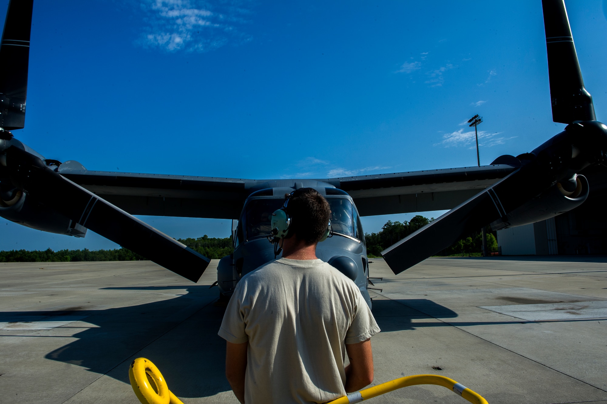 U.S. Air Force Airman 1st Class Tucker Clark, a crew chief for 801st Special Operations Aircraft Maintenance Squadron, looks over a CV-22 during routine inspections before the aircraft can take flight on Hurlburt Field, Fla., July 17, 2012. The squadron’s mission is to perform all equipment maintenance in support of worldwide special operations missions in response to national command authority tasking for the CV-22 and the MC-130H Combat Talon II. (U.S. Air Force photo/Airman 1st Class Christopher Williams)(Released)