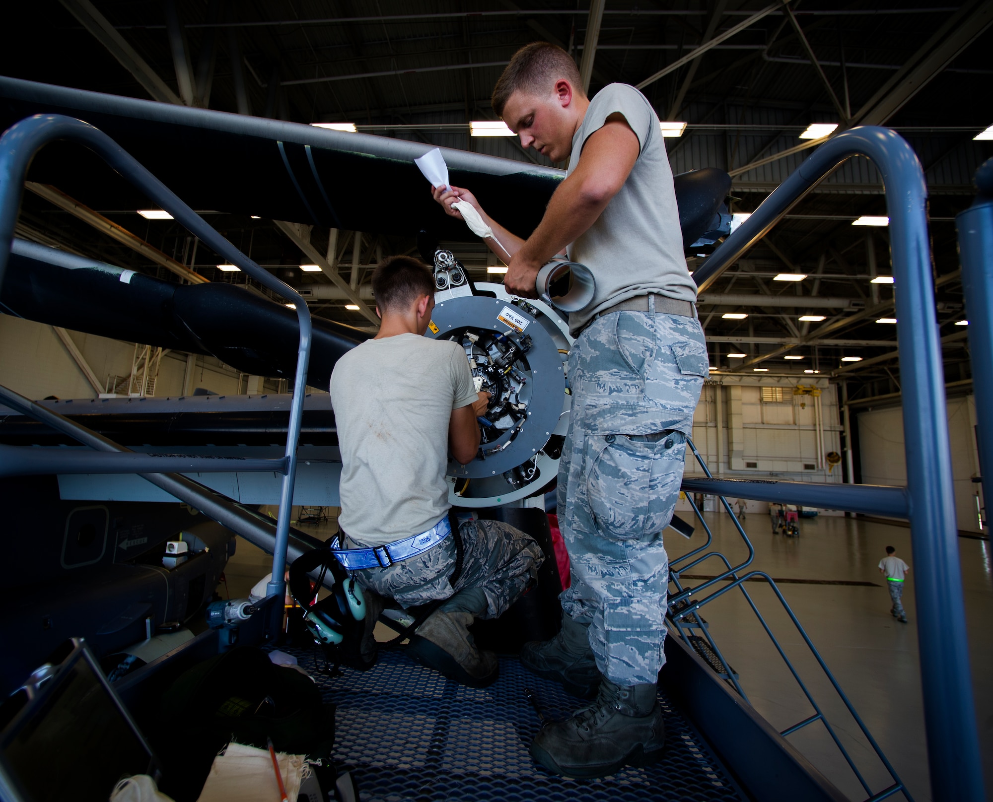 U.S. Air Force Airman 1st Class Robert Gentry III (left) and Airman 1st Class Jeremy Kanapaux (right), crew chiefs from 801st Special Operations Aircraft Maintenance Squadron, work on a CV-22 propeller at the Freedom Hangar on Hurlburt Field, Fla., July 17, 2012. The squadron was stood up on May 18, 1944 and was called the 16th Floating Repair Unit. (U.S. Air Force photo/Airman 1st Class Christopher Williams)(Released)