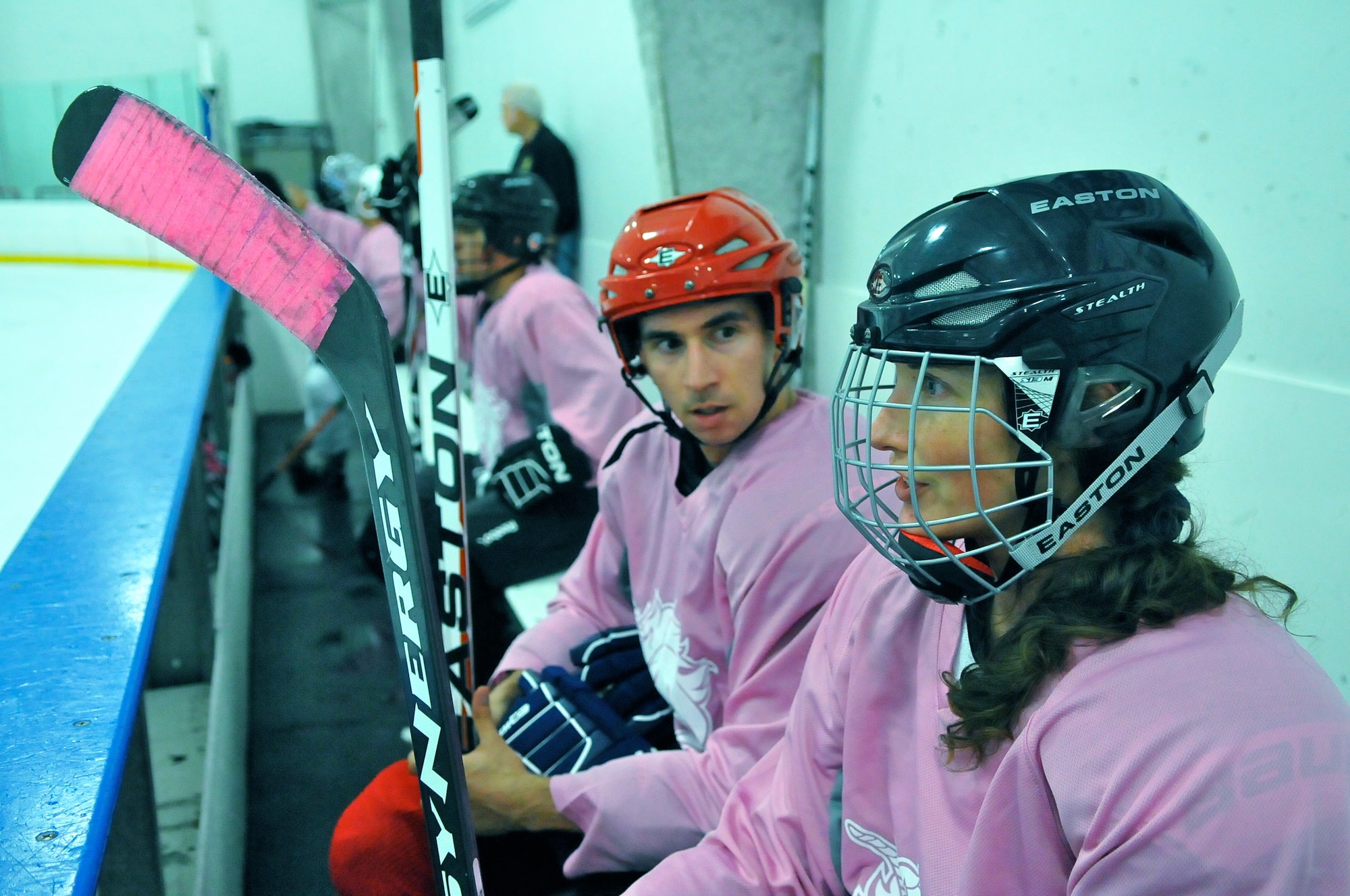 SAN ANTONIO -- 1st Lt. Andrew Caulk, of the Air Force Intelligence, Surveillance and Reconnaissance Agency and 1st Lt. Jennifer Caulk from the 453 Electronic Warfare Squadron at Lackland Air Force Base, Texas, talk strategy on the bench July 20 at the Ice and Golf Center at Northwoods here, during their game in the Adult Recreational Hockey League. Hockey is one of many sports the duo plays for fitness, fun and quality time together. (U. S. Air Force photo by William Belcher)     