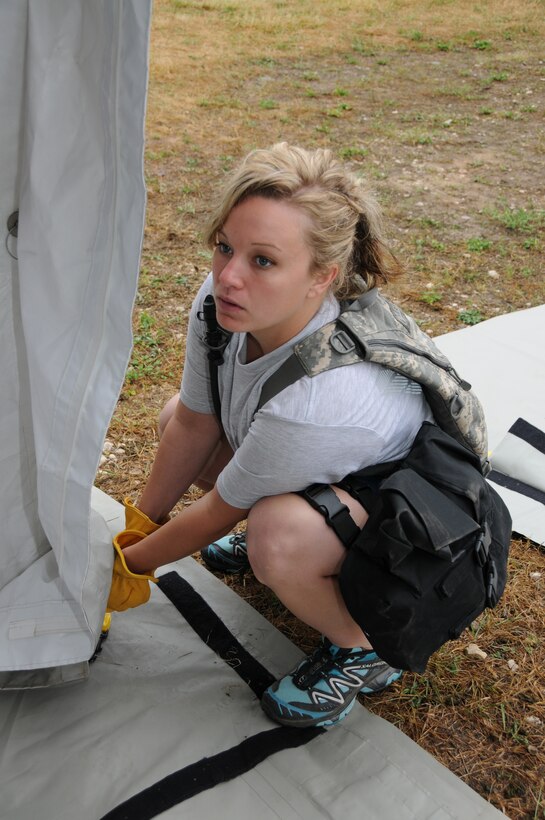 Senior Airman Ashley Frederick, 148th Fighter Wing, Minnesota Air National Guard helps put up a tent July 19, 2012 in support of PATRIOT 2012.  PATRIOT 2012 is an annual National Guard emergency reponse exercise and is comprised of more than 1,100 military and civilian personnel.  (National Guard photo by Master Sgt. Ralph J. Kapustka/Released)