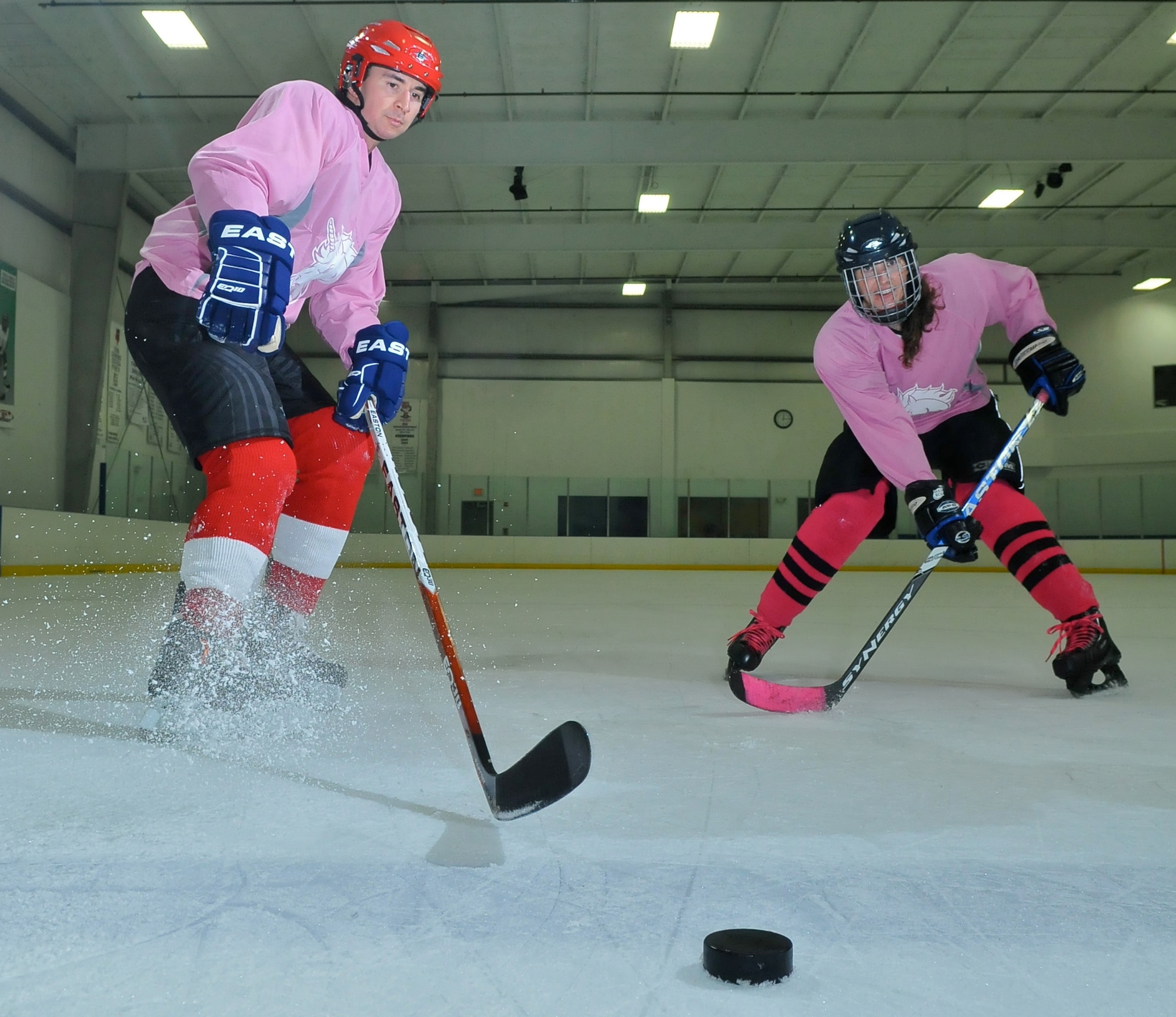 SAN ANTONIO -- 1st Lt. Andrew Caulk of the Air Force Intelligence, Surveillance and Reconnaissance Agency and 1st Lt. Jennifer Caulk from the 453 Electronic Warfare Squadron at Lackland Air Force Base, Texas, pose July 20 at the Ice and Golf Center at Northwoods here following their game in the Adult Recreational Hockey League. Hockey is one of many sports the duo plays for fitness, fun and quality time together. (U. S. Air Force photo  by William Belcher)     