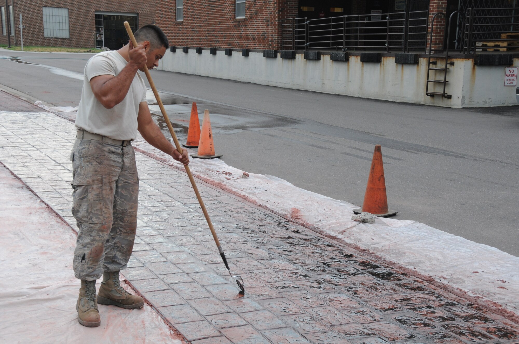 Members of the 934th Civil Engineer Squadron install a new brick paver walkway along 5th Street July 20. (Air Force Photo/Tech. Sgt. Scott Farley)  