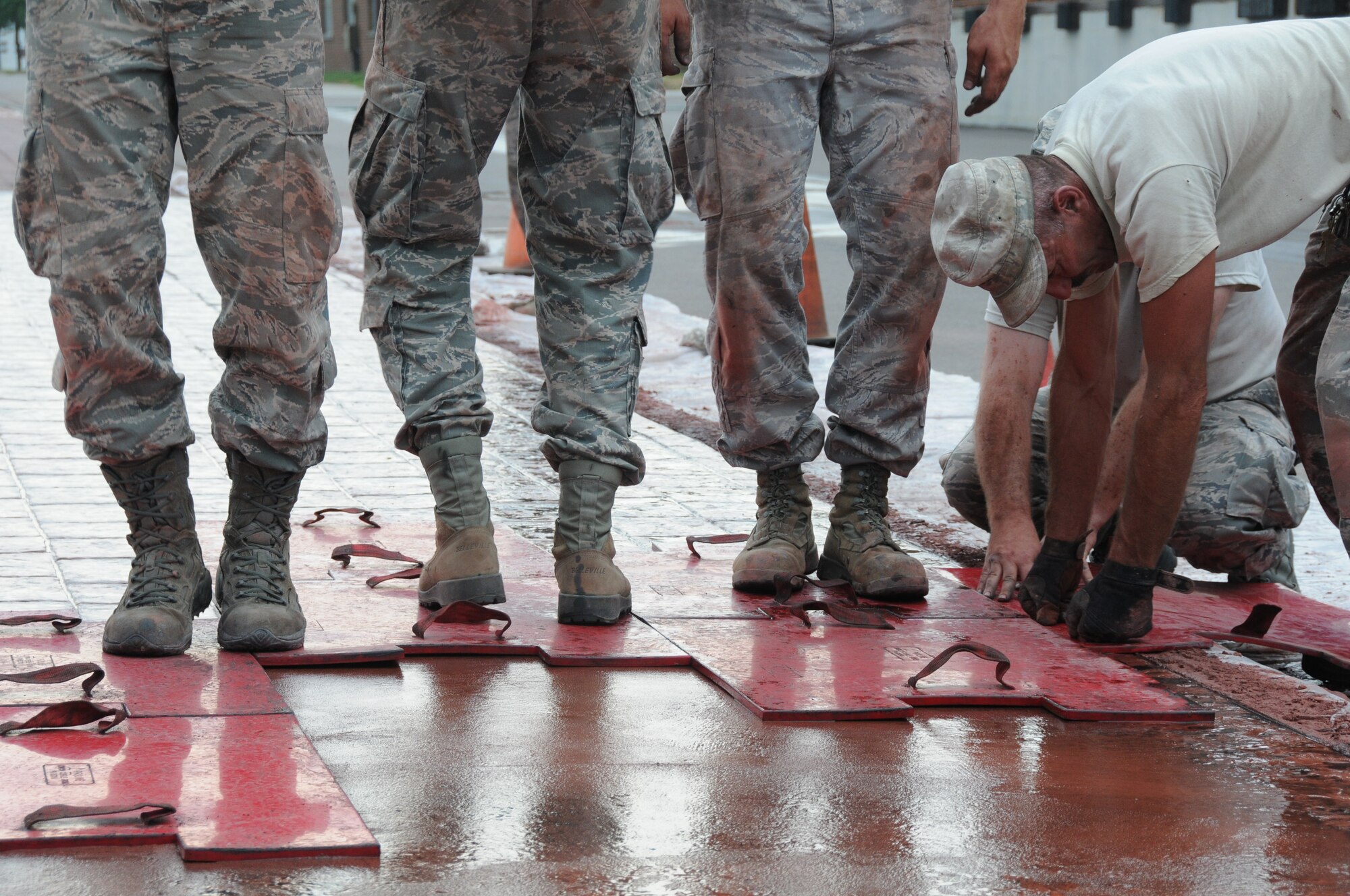 Members of the 934th Civil Engineer Squadron install a new brick paver walkway along 5th Street July 20. (Air Force Photo/Tech. Sgt. Scott Farley) 