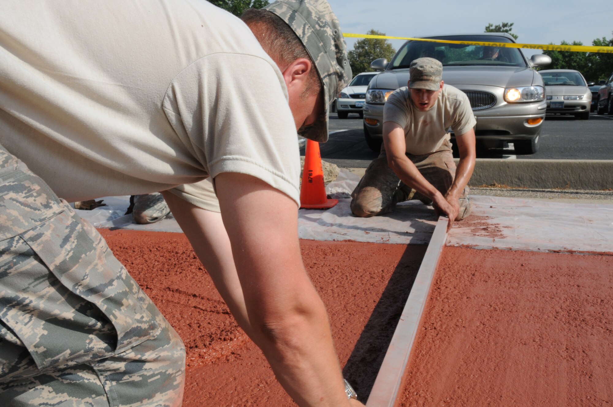 Members of the 934th Civil Engineer Squadron install a new brick paver walkway along 5th Street July 20. (Air Force Photo/Tech. Sgt. Scott Farley) 