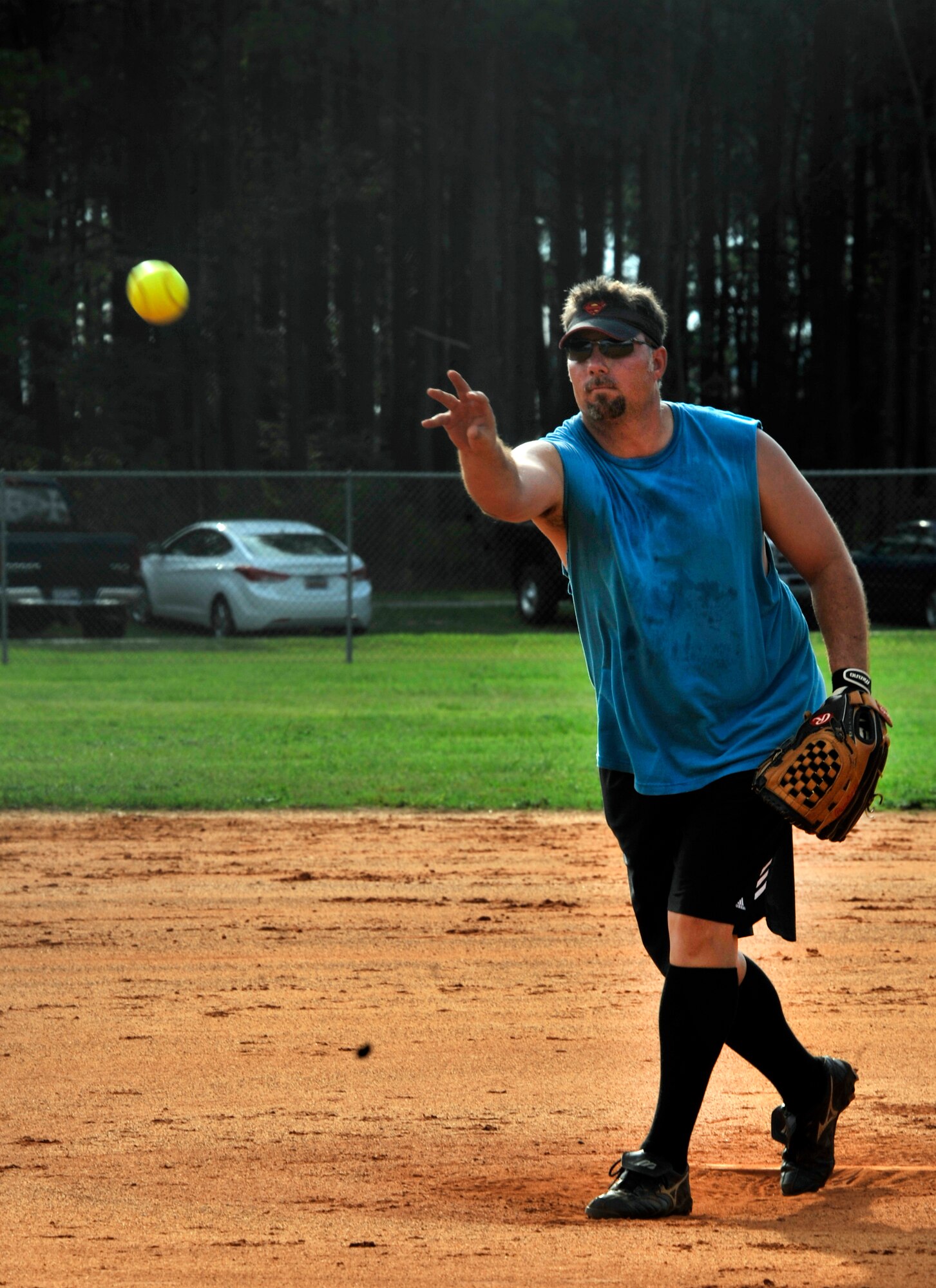 Adrian McDaniel pitches a softball to the opposing team during a softball game at Shaw Air Force Base, S.C., July 17, 2012. With about 30 games left before the playoffs, the 20th Civil Engineer Squadron won 13 to 8 against the 20th Maintenance Operations Squadron. (U.S. Air Force photo by Senior Airman Tabatha McCarthy/ released)