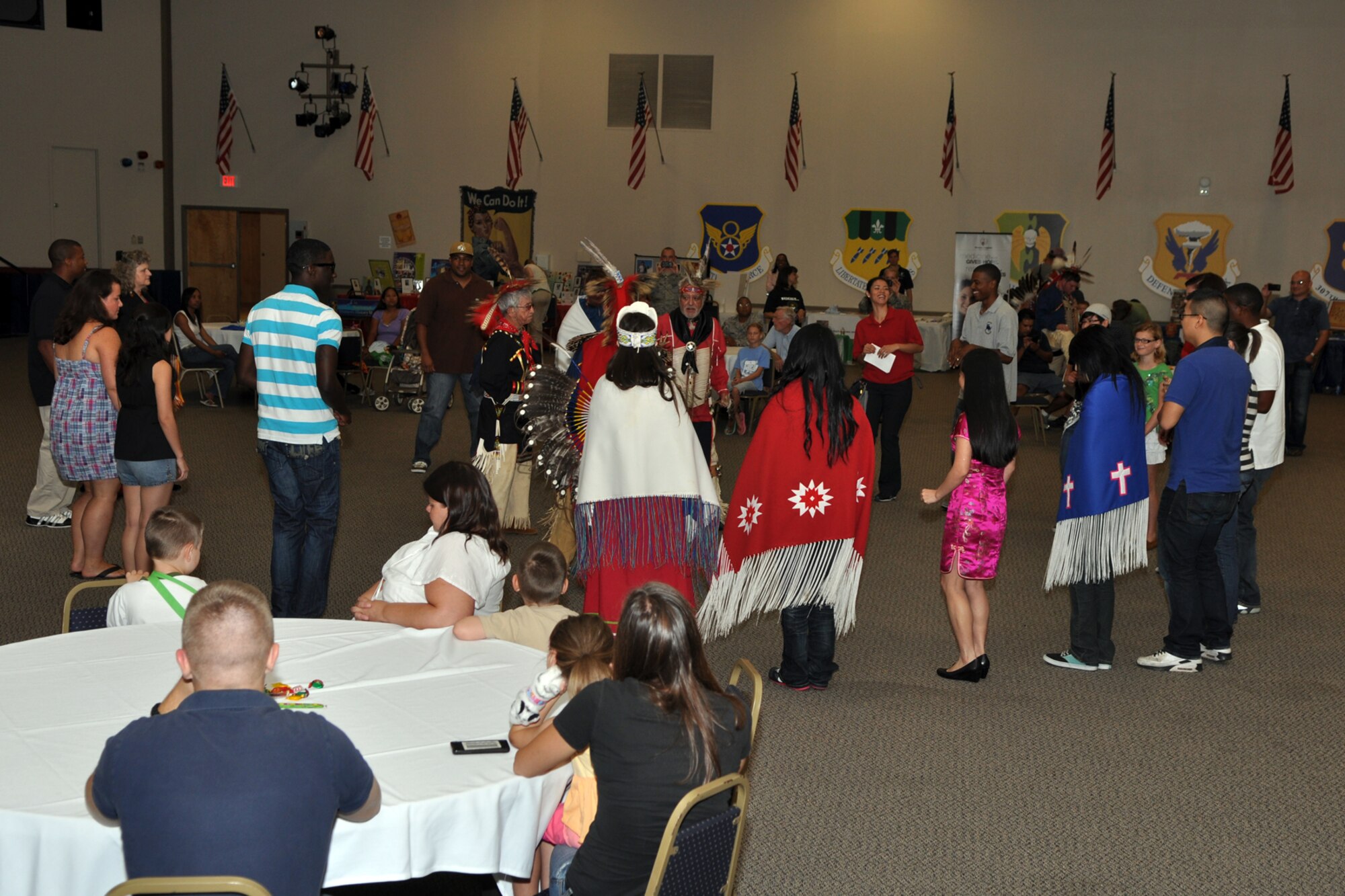Some attendees at the Multicultural Day celebration join Native American dancers during a "Friendship Dance" in Hoban Hall at Barksdale Air Force Base, La., July 20, 2012. (U.S. Air Force photo by Master Sgt. Jeff Walston)