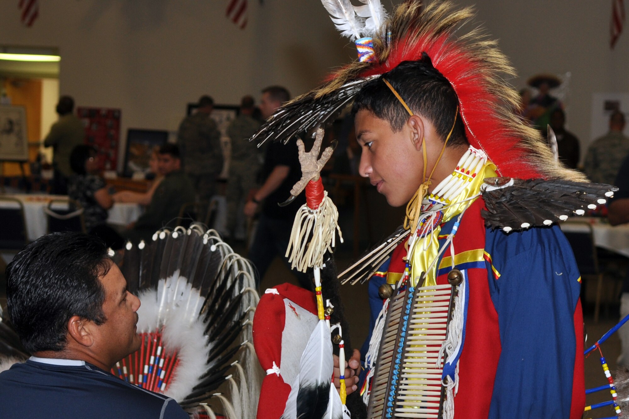 Hunter Leyva discusses his upcoming dance routine with his father Tavo at the Multicultural Day celebration in Hoban Hall at Barksdale Air Force Base, La., July 20, 2012. Hunter, who is a 9th grade student at Natchitoches Central High School, performed several Native American dances for the crowd. (U.S. Air Force photo by Master Sgt. Jeff Walston)