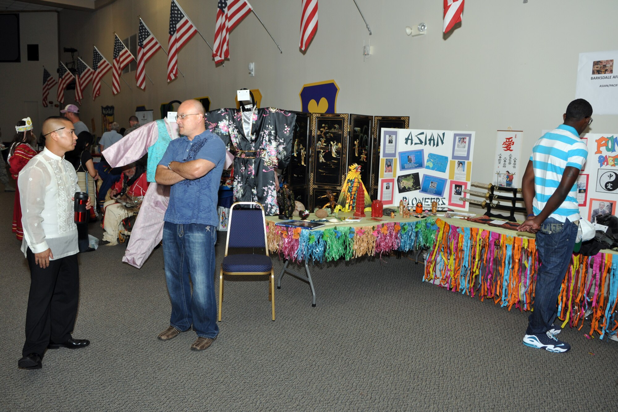 U.S. Air Force Master Sergeants Arman Soriano, NCOIC of Intel Standards and Evaluation for Air Force Global Strike Command and Will Dominy, the distribution section supervisor for the 2nd Logistics Readiness Squadron, enjoy the Barksdale AFB Multicultural Day celebration in Hoban Hall at Barksdale Air Force Base, La., July 20, 2012. Soriano and Dominy were on hand to answer questions about their Asian/Pacific Islander Heritage. (U.S. Air Force photo by Master Sgt. Jeff Walston) 