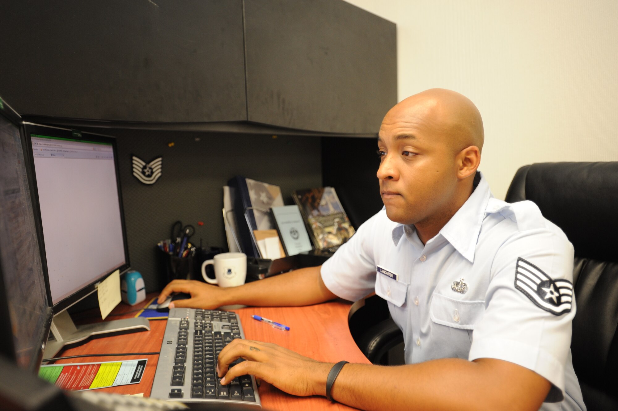 Staff Sgt. Marlon Lancaster, 22nd Air Refueling Wing Protocol NCO in charge, fills out forms for an upcoming designated visitor July 23, 2012 at McConnell Air Force Base, Kan. Lancaster is responsible for the timely completeion of any activities the protocol office is in charge of. (U.S. Air Force photo/Airman 1st Class Victor J. Caputo)