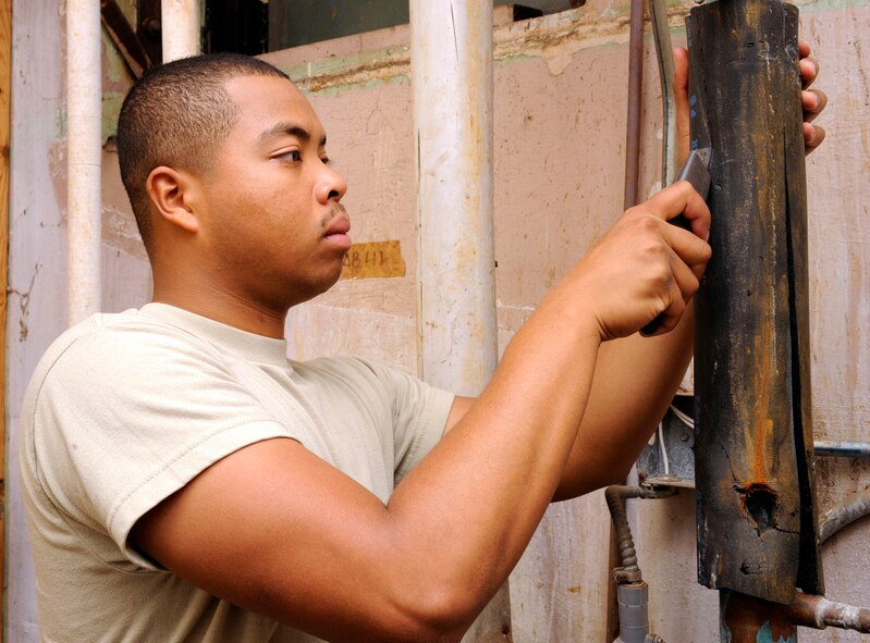 Senior Airman David Murriel, 2nd Civil Engineering Squadron heating, ventilation, air conditioning/refrigeration technician, cuts away pipe insulation to locate a leak on Barksdale Air Force Base, La., July 24. HVAC/R Airmen are responsible for maintaining and monitoring Barksdale?s humidity levels and heating and cooling systems, in buildings across the base. (U.S. Air Force photo/Airman 1st Class Andrew Moua)(RELEASED)