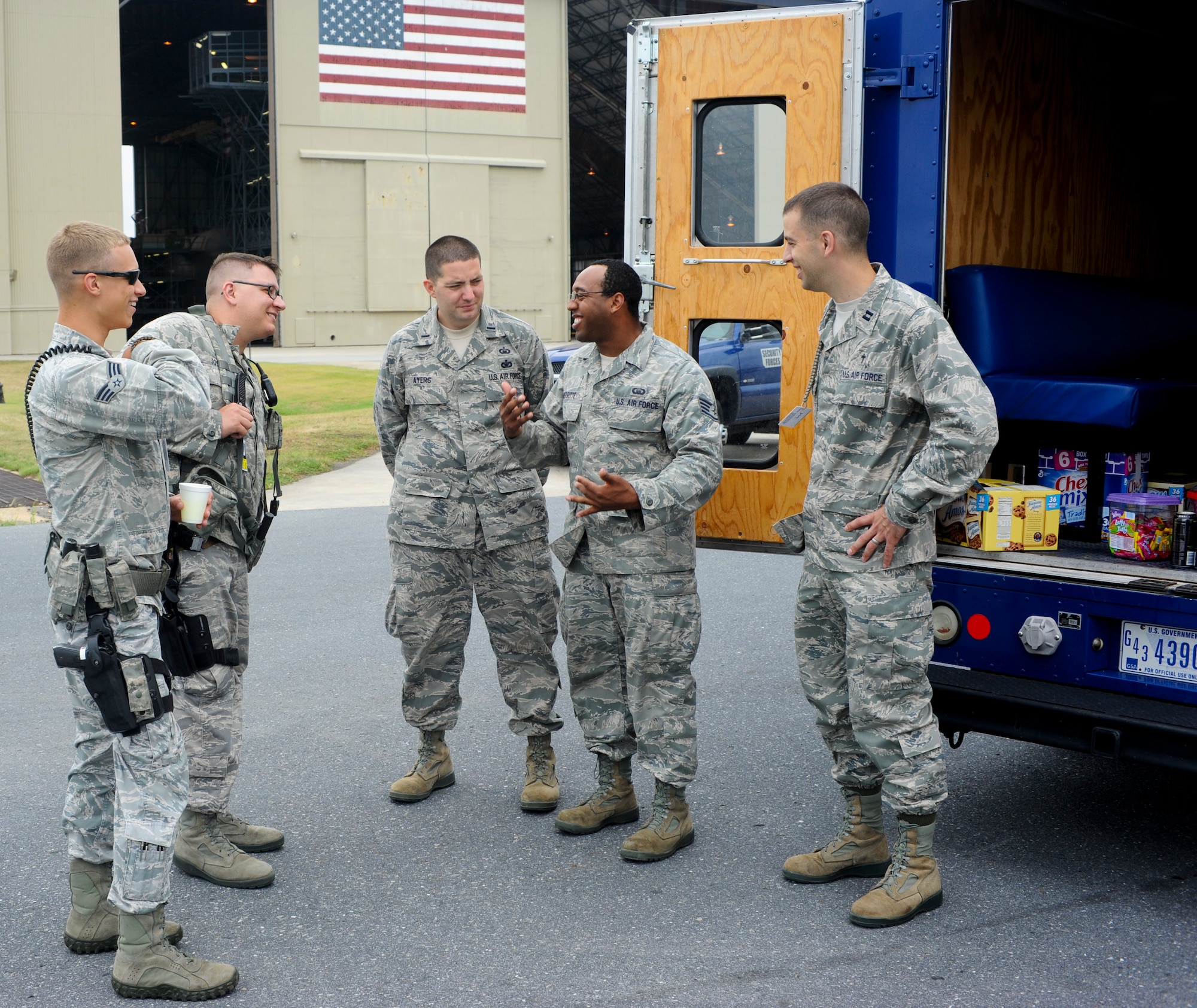 Staff Sgt. Javon Merritte (second from right), chaplain’s assistant with the 436th Airlift Wing, builds rapport with Airmen on the flightline at Dover Air Force Base, Del., July 20, 2012. Chaplain’s assistants form religious support teams with chaplains to get face time with troops, sometimes utilizing the “Holy Roller”, a supply vehicle, to distribute food and drinks to those who work outside in the elements. (U.S. Air Force photo by Airman 1st Class Kathryn Stilwell)
