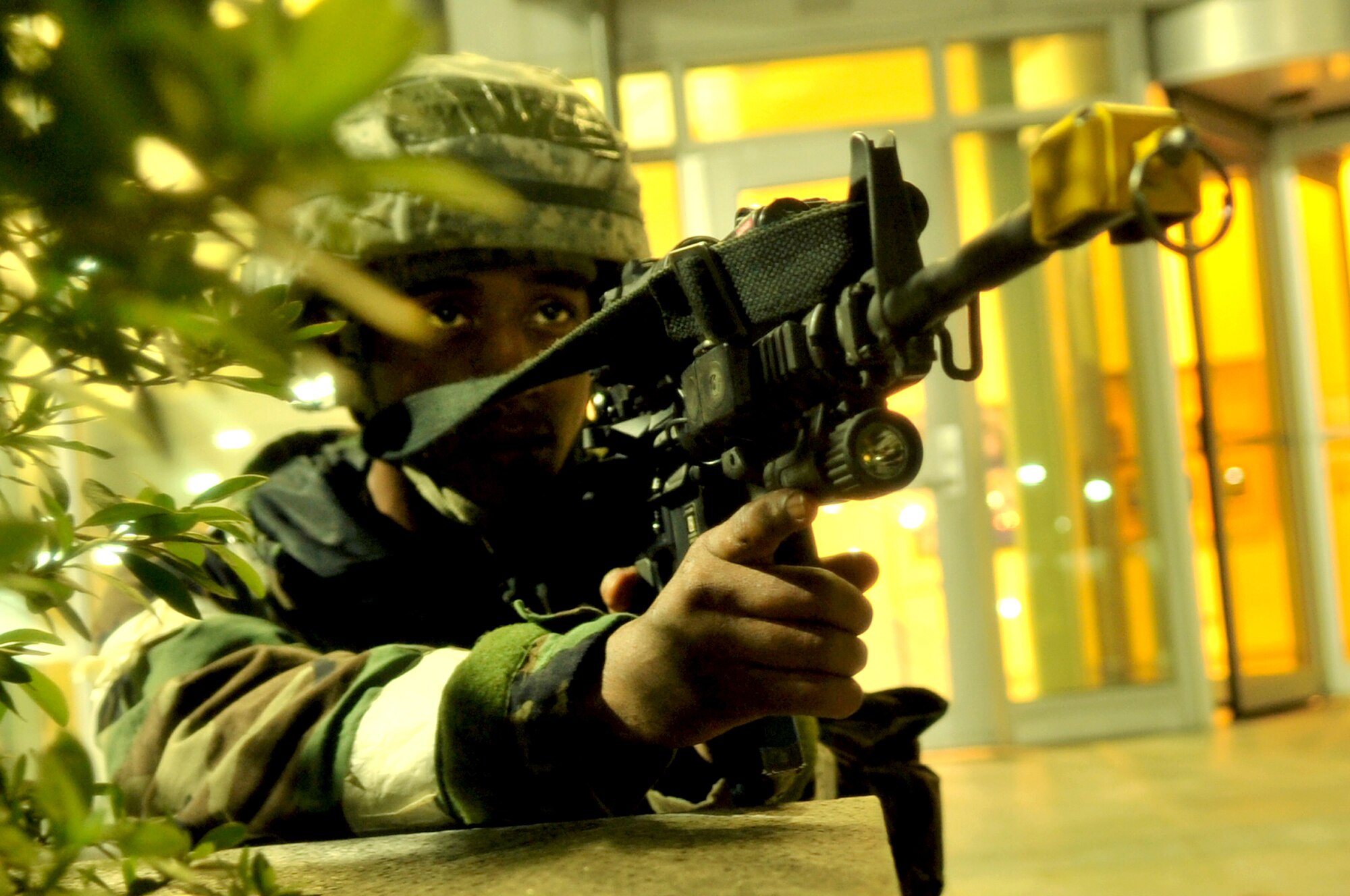 Airman 1st Class James Banks crouches into a defensive fighting position at Osan Air Base, Republic of Korea, July 24, 2012. Team Osan is participating in operational readiness exercise Beverly Midnight 12-03, which tests the base’s operational ability during a heightened state of readiness. Banks is with the 51st Security Forces Squadron. (U.S. Air Force photo/Staff Sgt. Stefanie Torres) 