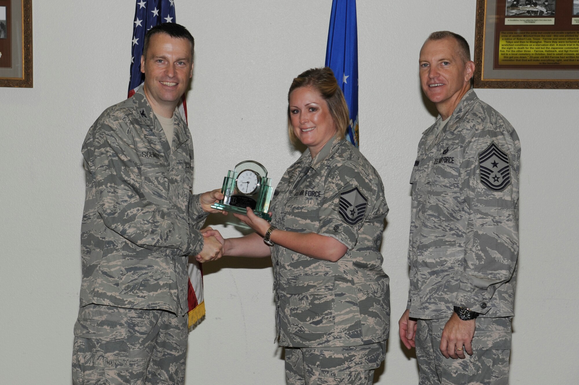 Col. Thomas Schmidt, 17th Training Wing Vice Commander, and Chief Master Sgt. Scott Lumpkin, 17th TRW Command Chief, present the 17th Training Wing Senior NCO of the Quarter to Master Sgt. Lorene Huffman, 314th Training Squadron, during the wing quarterly awards ceremony July 24. (U.S. Air Force photo by Staff Sgt. Austin Knox)