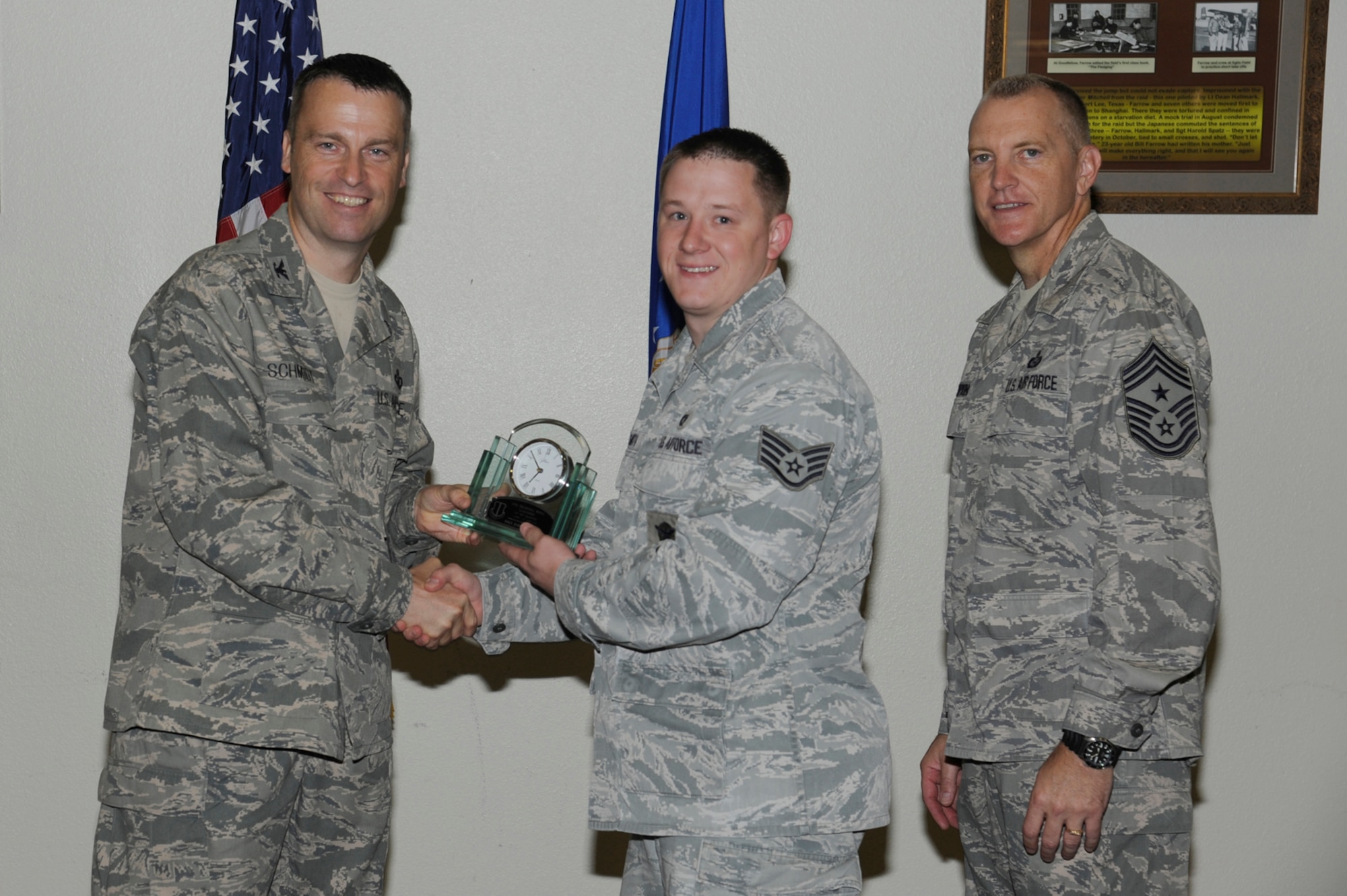 Col. Thomas Schmidt, 17th Training Wing Vice commander, and Chief Master Sgt. Scott Lumpkin, 17th TRW Command Chief, present the 17th Training Wing Volunteer of the Quarter to Staff Sgt. Jeremy Smith, 17th Security Forces Squadron, during the wing quarterly awards ceremony July 24. (U.S. Air Force photo by Staff Sgt. Austin Knox)