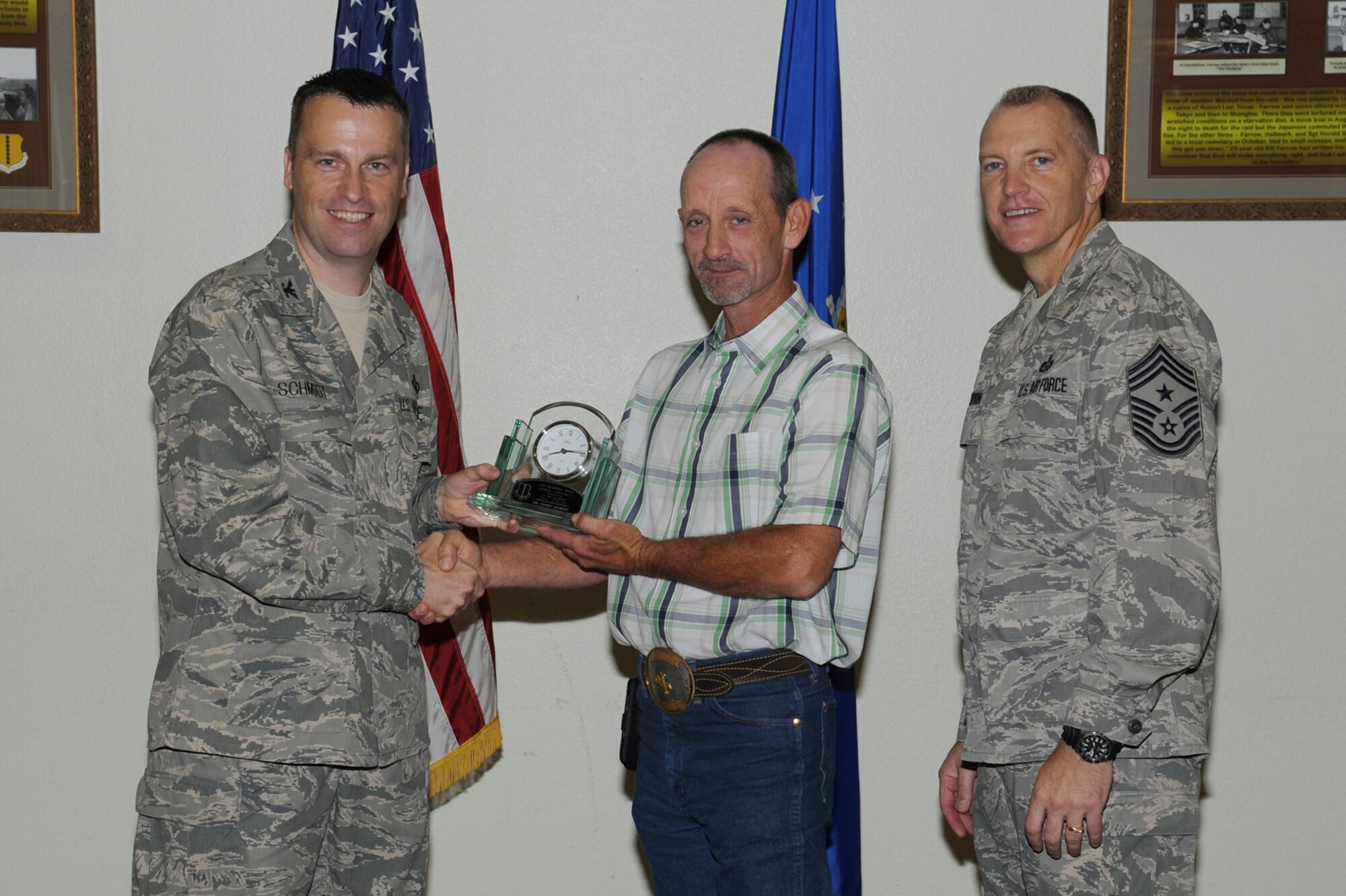 Col. Thomas Schmidt, 17th Training Wing Vice Commander, and Chief Master Sgt. Scott Lumpkin, 17th TRW Command Chief, present the 17th Training Wing Civilian Supervisor of the Quarter Category I to Harry Gilbert, 17th Force Support Squadron, during the wing quarterly awards ceremony, July 24. (U.S. Air Force photo by Staff Sgt. Austin Knox)