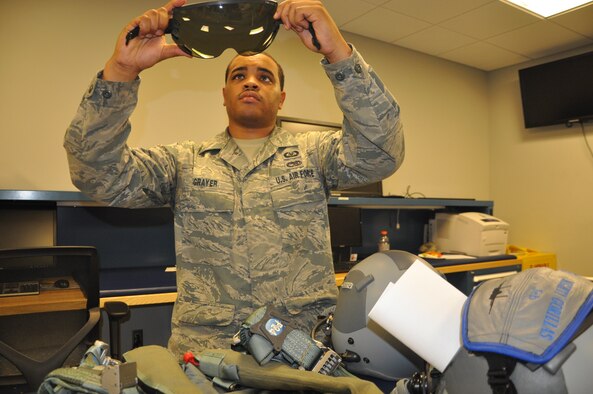 Staff Sgt. Kevin Grayer, 33rd Operations Support Squadron aircrew flight equipment technician, inspects a helmet shield for the pilots flying F-16 Fighting Falcons who accompany the F-35A Lightning II pilots during routine flight operations at the 33rd Fighter Wing. During a unit compliance inspection in July, the AFE section was cited by the inspector general team as saving the Air Force $135 thousand in equipment procurement, and orchestrating a savings of $15,000 for renovating the AFE training classroom with a self-help project that included painting and laying carpet. (U.S. Air Force photo/Maj. Karen Roganov)