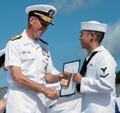 Petty Officer 3rd Class Daniel Araki receives the Class Honorman award for Enlisted Class 1105 from Rear Adm. Richard Breckenridge, Submarine Group Two commander, during the Naval Nuclear Power Training Command graduation ceremony July 20, 2012, at Joint Base Charleston - Weapons Station, S.C. The Honorman award is given to the Sailor with the highest grade point average. (U.S. Air Force photo/Airman 1st Class Ashlee Galloway)
