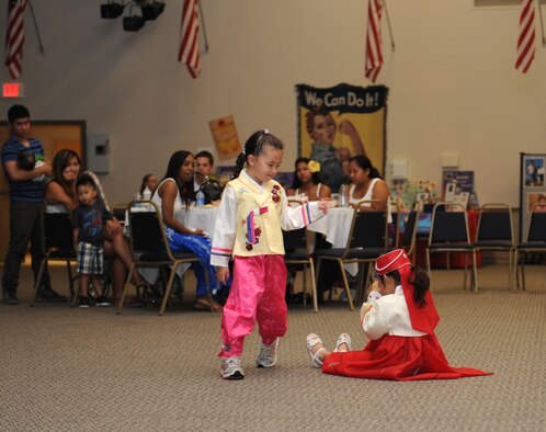 Two girls perform the Korean Puppet Dance, or Kok Tu Gak Shi, during Multicultural Day on Barksdale Air Force Base, La., July 20. The dance, which contains eight acts, tells the story of social life amongst common people in past Korean society. The hidden message of the dance is the struggle the poor class has against the corrupted ruling government. The dance originated more than 2,000 years ago during the Silla period. (U.S. Air Force photo/Airman 1st Class Benjamin Gonsier)(RELEASED)