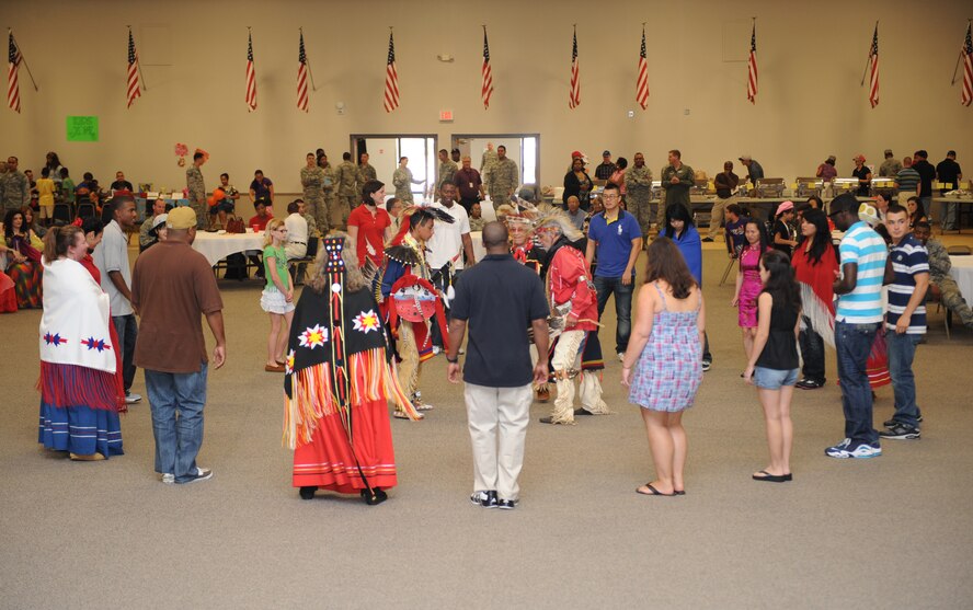 The Adai Caddo, a Native American tribe, and members of Team Barksdale gather in the middle of Hoban Hall to perform a Native American dance during Multicultural Day on Barksdale Air Force Base, La., July 20. The Adai Caddo Indian Nation has more than 1,200 tribal members from all across the nation. (U.S. Air Force photo/Airman 1st Class Benjamin Gonsier)(RELEASED)
