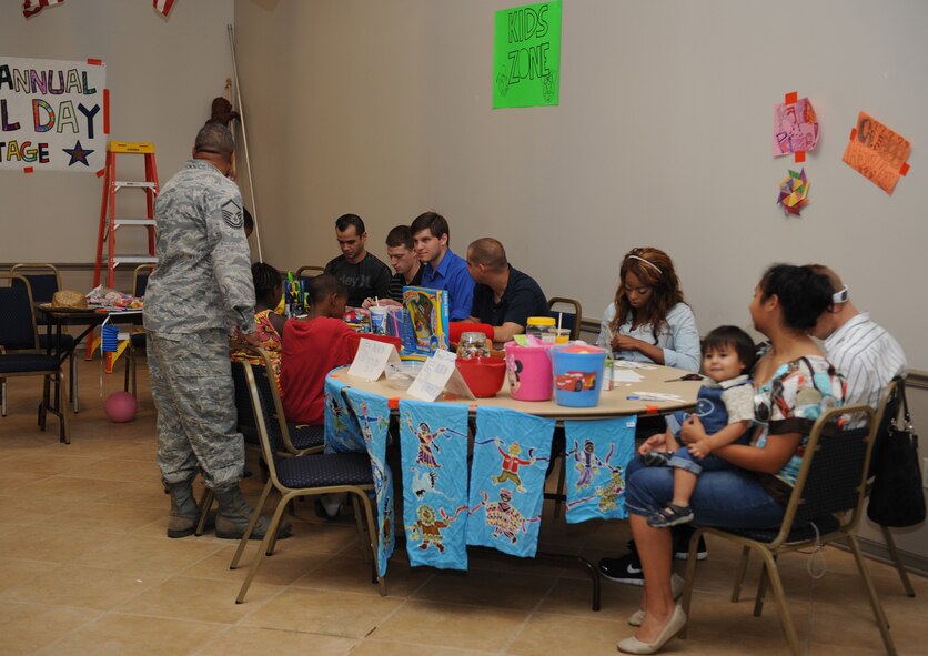 Members of Team Barksdale participate in arts and crafts during Multicultural Day on Barksdale Air Force Base, La., July 20. Multicultural Day gives Airmen and their families the opportunity to view the variety of cultures that make up the Air Force. The event contained booths displaying various artifacts and food samples and dance performances from various cultures. (U.S. Air Force photo/Airman 1st Class Benjamin Gonsier)(RELEASED)