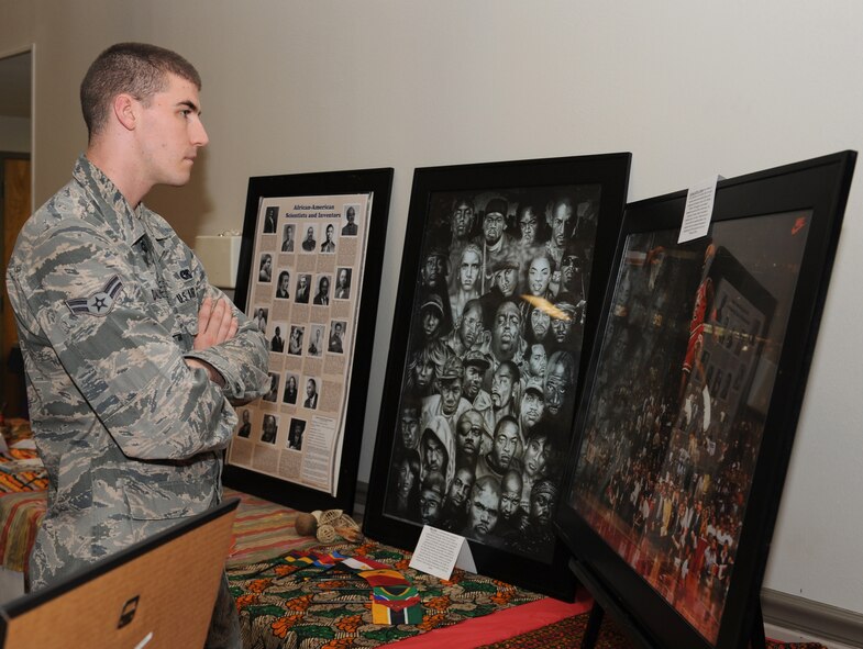 Airman 1st Class Christopher Dalton, 2nd Logistics Readiness Squadron, looks at a display at the African American booth during Multicultural Day on Barksdale Air Force Base, La., July 20. The booth displayed facts about famous African American musical artists, scientist, inventors and athletes as well as cultural artifacts. (U.S. Air Force photo/Airman 1st Class Benjamin Gonsier)(RELEASED)