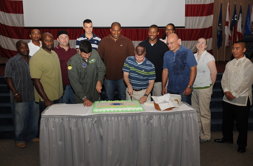 Col. Andrew Gebara, 2nd Bomb Wing commander, and Master Sgt. Darren Mitchell, 608th Air Communications Squadron, cut a cake to kick off Multicultural Day on Barksdale Air Force Base, La., July 20. Multicultural Day is an annual event that celebrates the diversity of Barksdale Airmen and their families. (U.S. Air Force Photo/Airman 1st Class Benjamin Gonsier)(RELEASED)