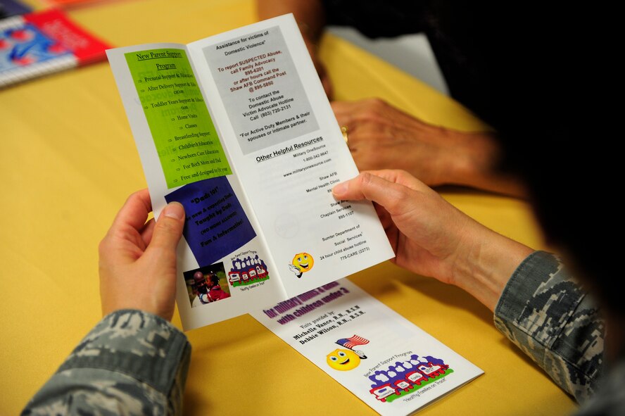 Chaplain (Capt.) Katherine Scott, 20th Fighter Wing chaplain and expecting mother, reads over pre-natal and childcare information offered at the family advocacy program’s booth at a deployed spouses’ dinner, Shaw Air Force Base, S.C., July 23, 2012. The FAP attends events such as these to pass out information on the various programs they offer. This assistance can be especially helpful to parents who are raising their children alone while their spouse is deployed. (U.S. Air Force photo by Airman 1st Class Daniel Blackwell/Released)