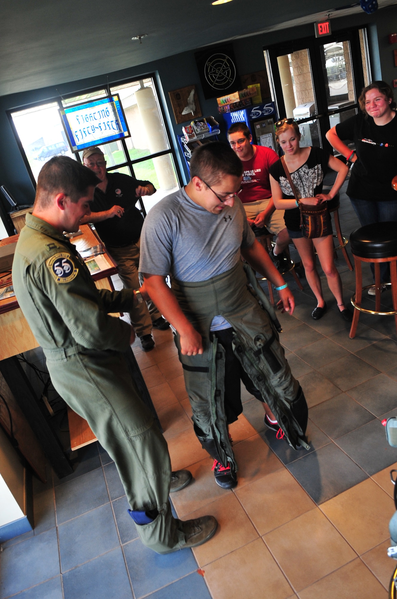 U.S. Air Force Capt. Chris Morton, 55th Fighter Squadron F-16 Fighting Falcon pilot, shows a group of high school students in aviation aerospace summer camp how to put on flight gear, Shaw Air Force Base, S.C., July 18, 2012. The group had the opportunity to tour several places on base to experience how the military works and the role Shaw plays in the big picture. (U.S. Air Force photo by Airman 1st Class Ashley L. Gardner/ Released)