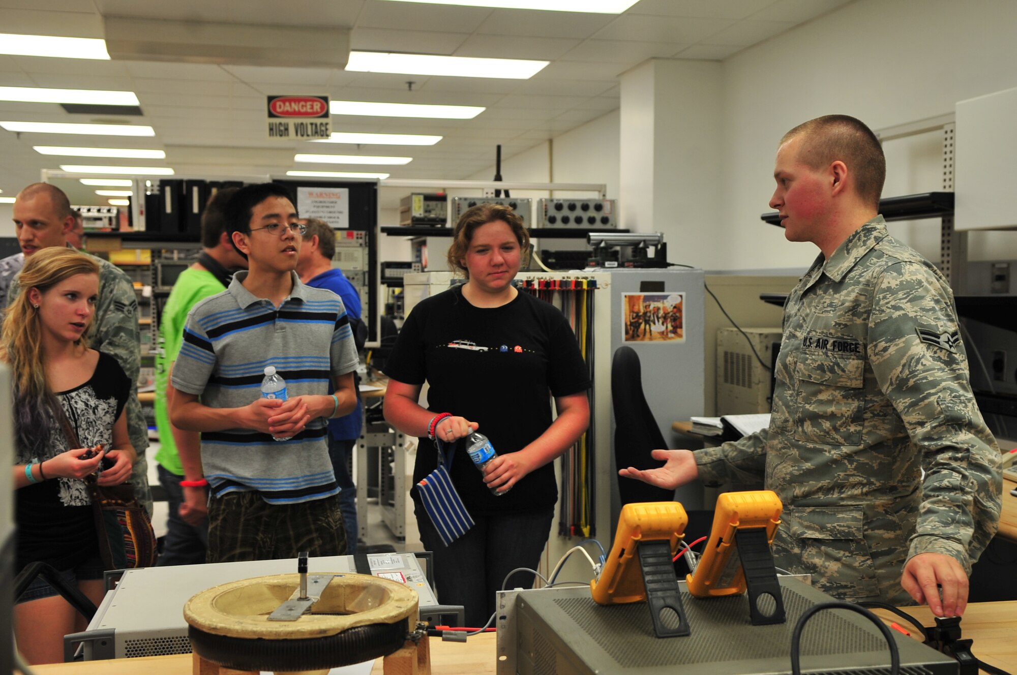 U.S. Air Force Airman 1st Class Paul Rose, 20th Component Maintenance Squadron precision measurement equipment lab technician, demonstrates what his job consists of to a group of high school students in aviation aerospace summer camp, Shaw Air Force Base, S.C., July 18, 2012. The group had the opportunity to tour the base to experience how the military works and the role Shaw plays in the big picture. (U.S. Air Force photo by Airman 1st Class Ashley L. Gardner/ Released)

