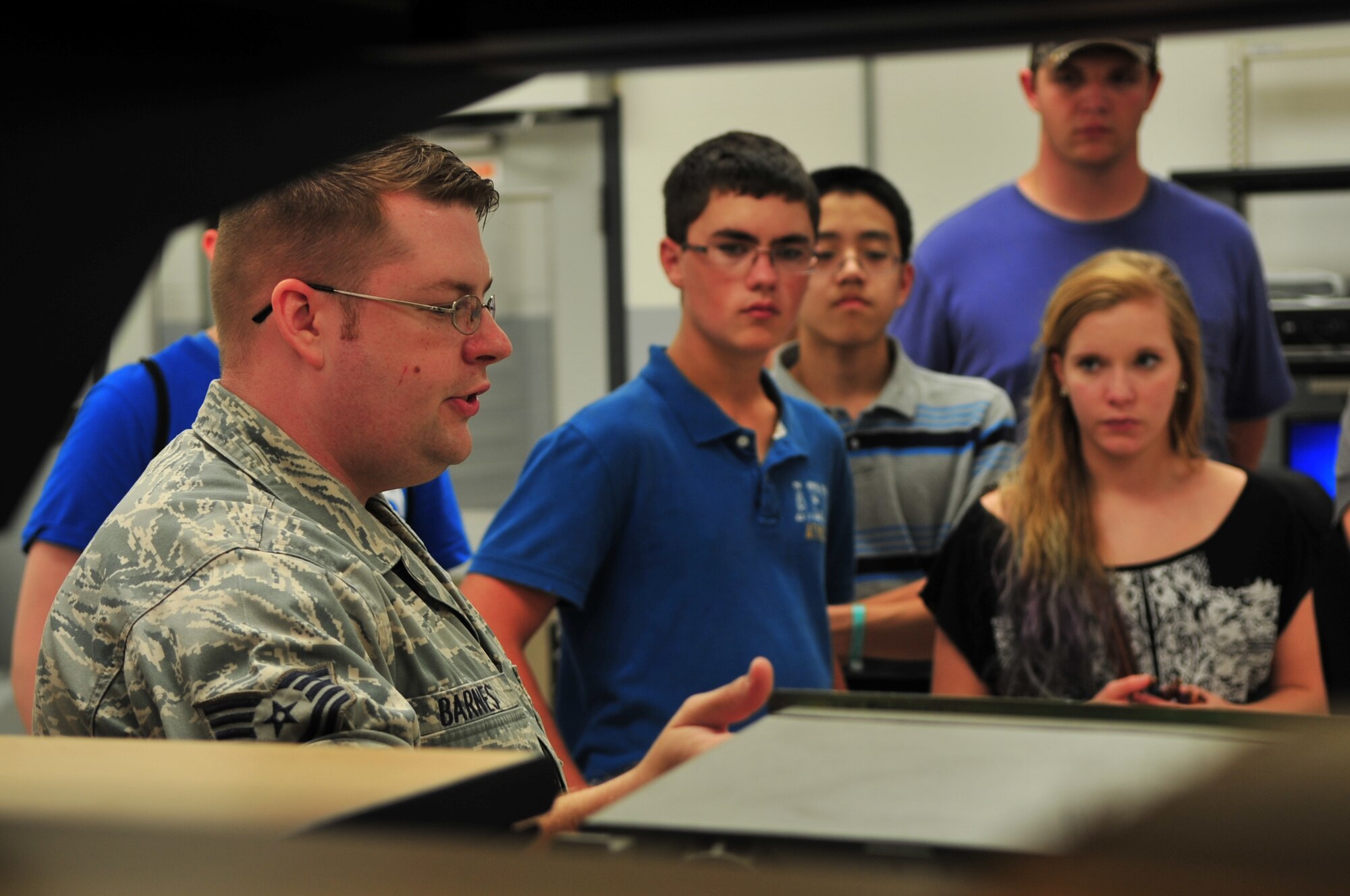 U.S. Air Force Tech. Sgt. Timothy Barnes, 20th Component Maintenance Squadron production control NCOIC, explains his job to a group of high school students in aviation aerospace summer camp, Shaw Air Force Base, S.C., July 18, 2012. The group had the opportunity to tour several places on base to experience how the military works and the role Shaw plays in the big picture. (U.S. Air Force photo by Airman 1st Class Ashley L. Gardner/ Released)

