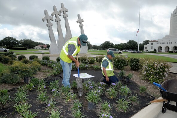Hector Montoya, left, and Hector Perez plant flowers around the Missing Man Monument on Joint Base San Antonio-Randolph, Texas, July 24, 2012. Montoya and Perez are Fairways Landscaping service professionals. (U.S. Air Force photo/Rich McFadden) 

