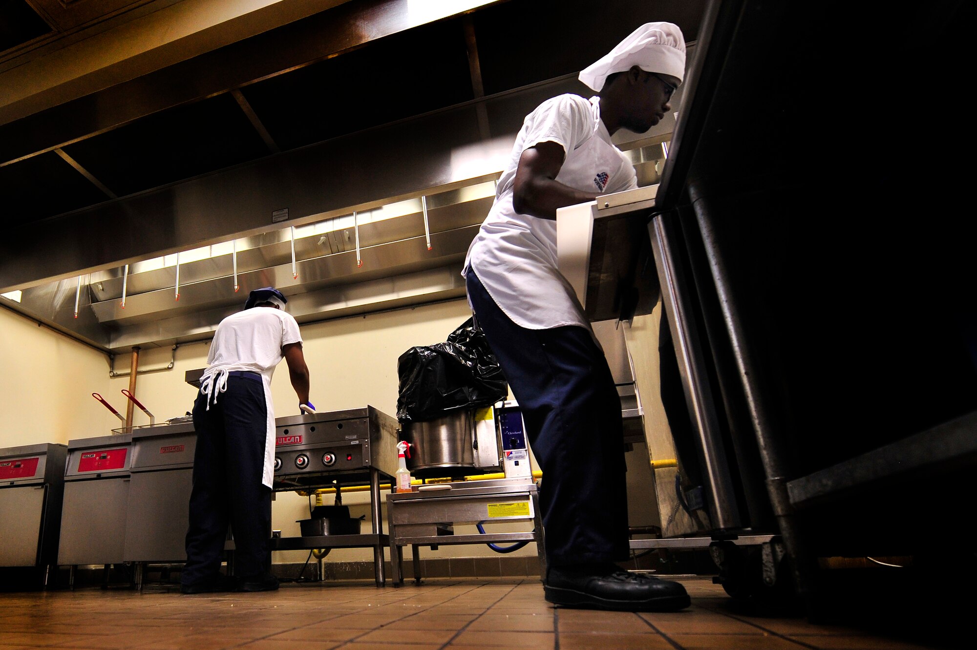 U.S. Air Force Senior Airman John Grant (left) and Airman 1st Class Wendell Walker, both 20th Force Support Squadron food service specialists, prepare chow for Airmen during a lunch hour rush at the Afterburner Grill, July 20, 2012, Shaw Air Force Base, S.C.  The Afterburner Grill is Shaw’s second dining facility which offers personnel working on the flightline a more accessible facility to get lunch and dinner while continuing to support Shaw’s flying mission. (U.S. Air Force photo by Senior Airman Kenny Holston/Released)