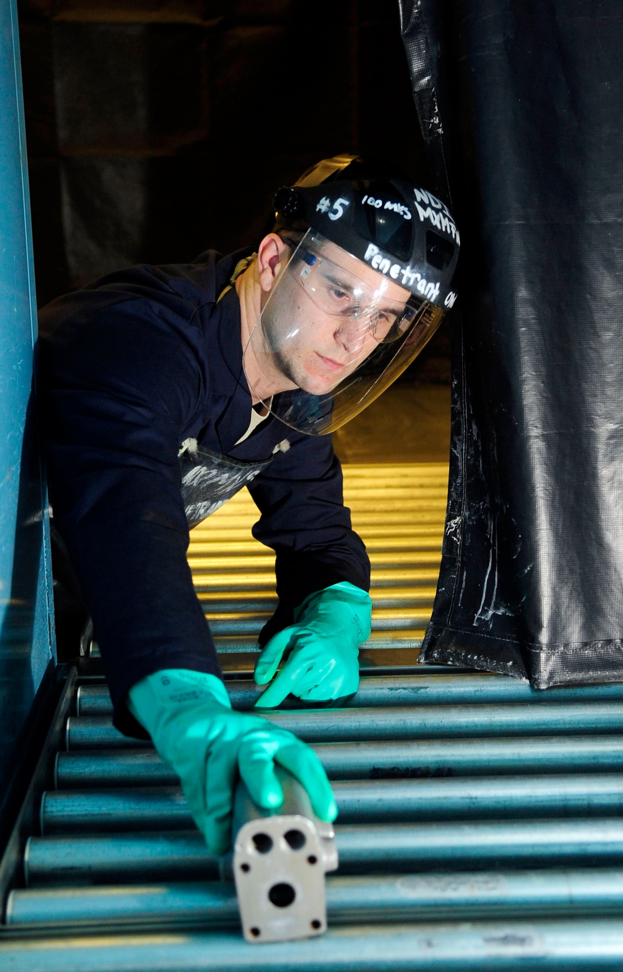 RAF MILDENHALL, England -- Staff Sgt. David Mazurowski, 100th Maintenance Squadron Non-Destructive Inspection craftsman, puts a KC-135 accumulator into a dryer during a fluorescent dye penetrant inspection at RAF Mildenhall July 18, 2012. The landing gear is placed in the dryer to dry off all remaining fluids that are present. This process leaves only the fluorescent dye penetrant present on the accumulator. (U.S. Air Force photo/Senior Airman Ethan Morgan)